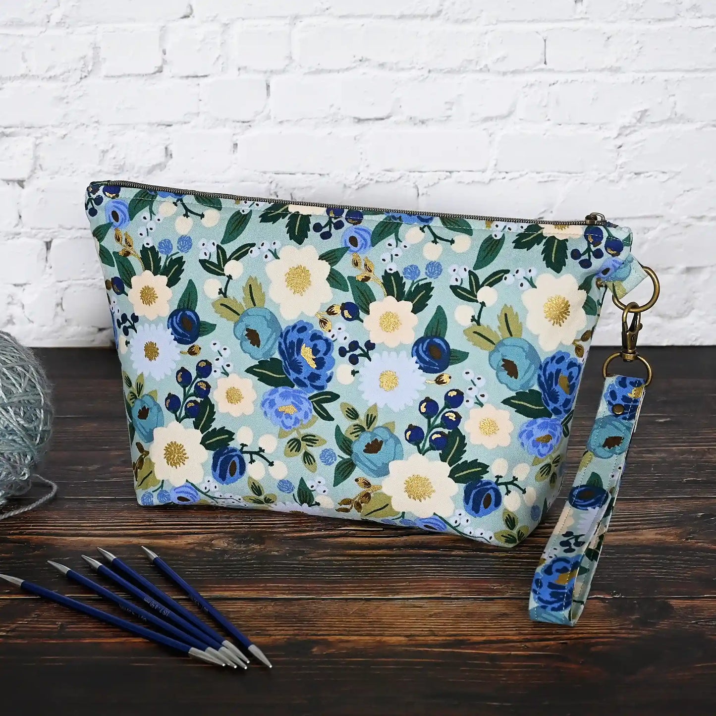 Beautiful pouch in an aqua floral fabric with gold detailing by Rifle Paper Co. Handmade in Nova Scotia, Canada by Yellow Petal Handmade.