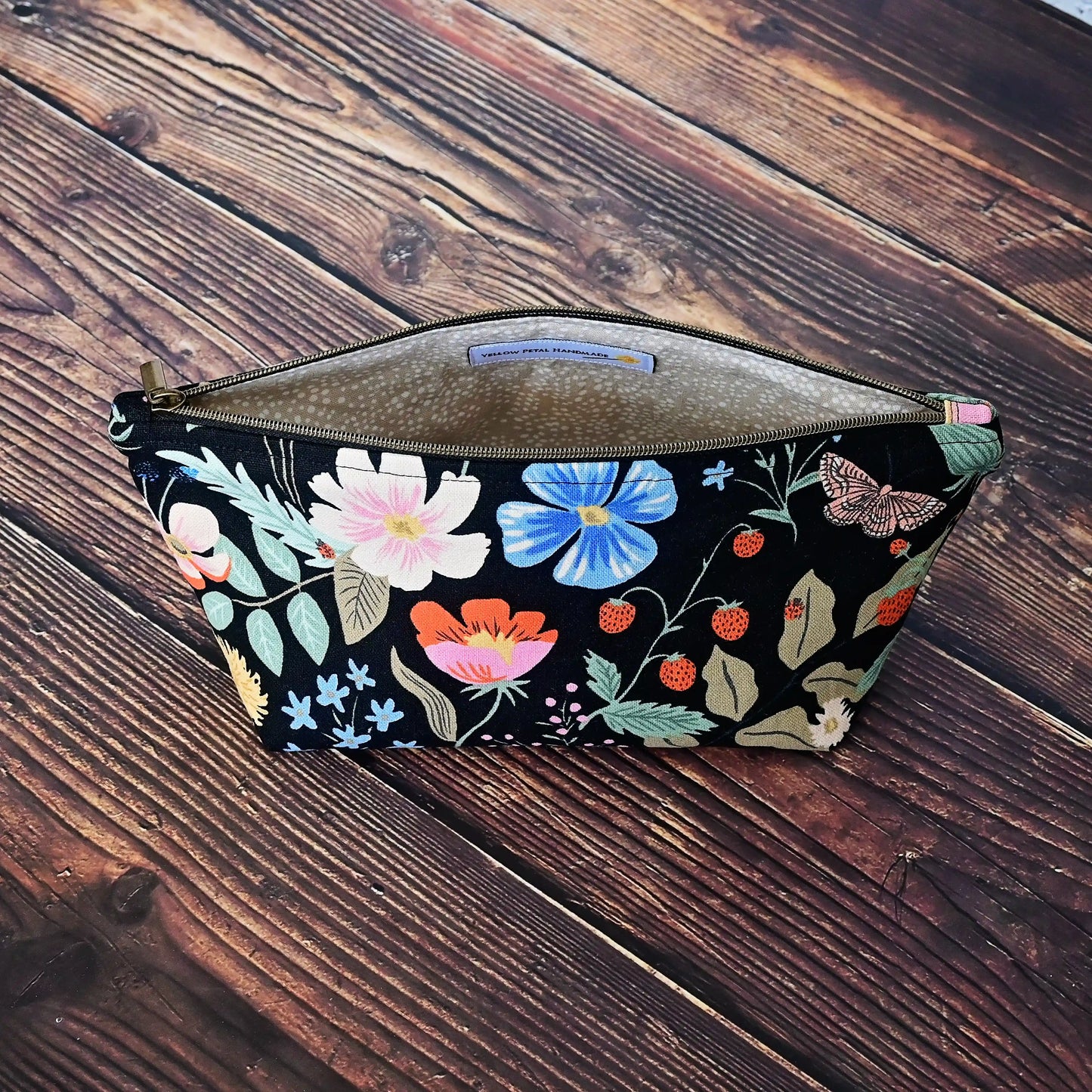 Cute black floral canvas accessory pouch in Rifle Paper Co's Strawberry Fields collection. Shown with 6" dpns. Made in Canada by Yellow Petal Handmade.