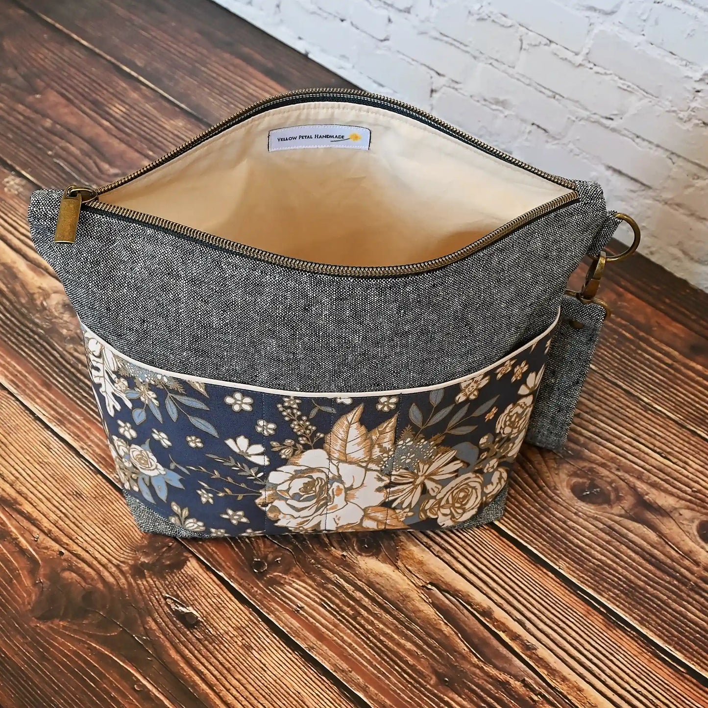 Beautiful linen project bag with exterior pockets made from a gorgeous navy floral cotton. Handmade in Canada by Yellow Petal Handmade.