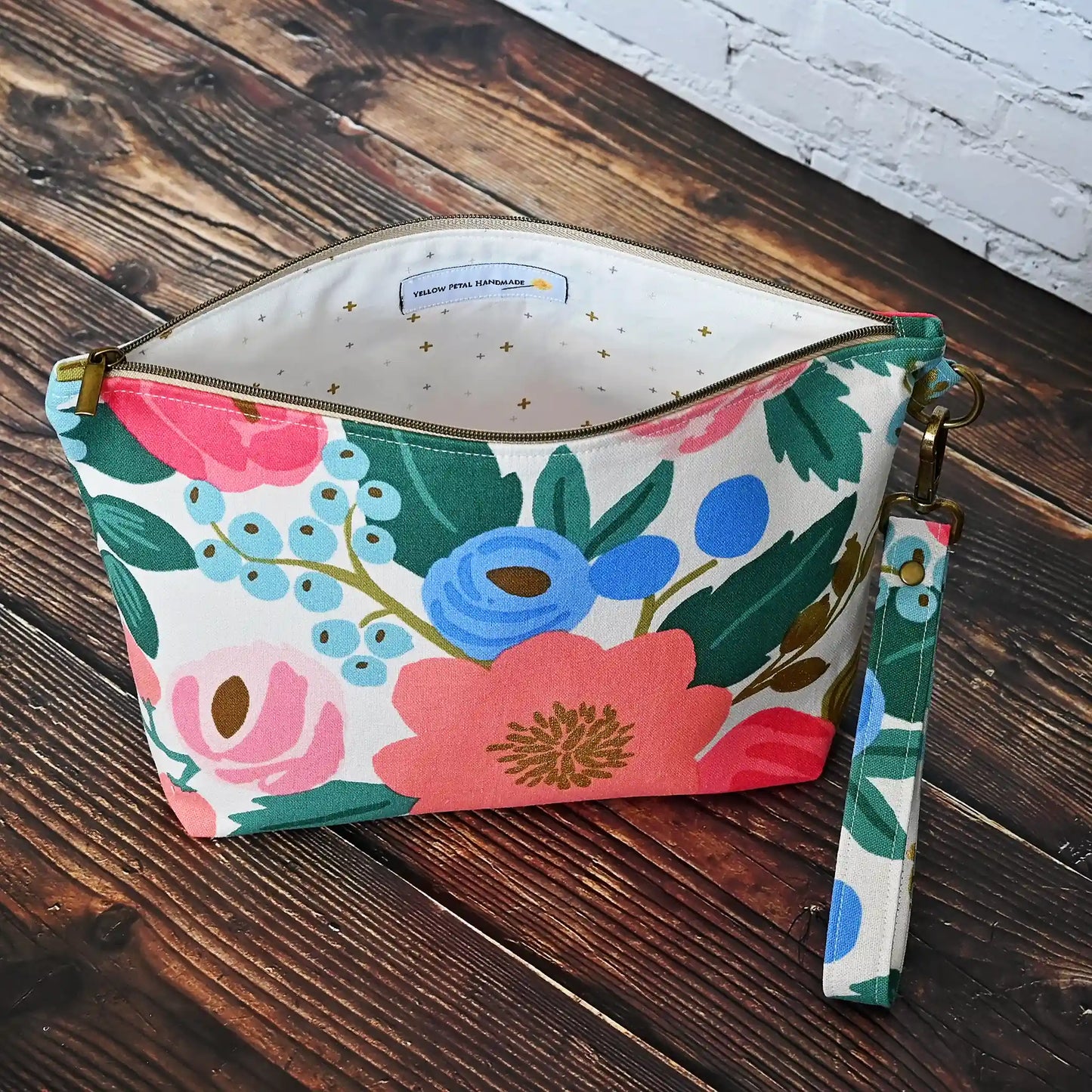 Cream floral canvas zippered pouch with removable wrist strap. Made from Rifle Paper Co's Antique Garden. Handmade in Nova Scotia, Canada.