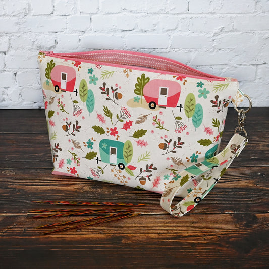 Fun cream camper patterned zippered pouch with a removable wrist strap.  Lined in a pretty pink and white spotted lining.  100% cotton.  Made in Canada by Yellow Petal Handmade.