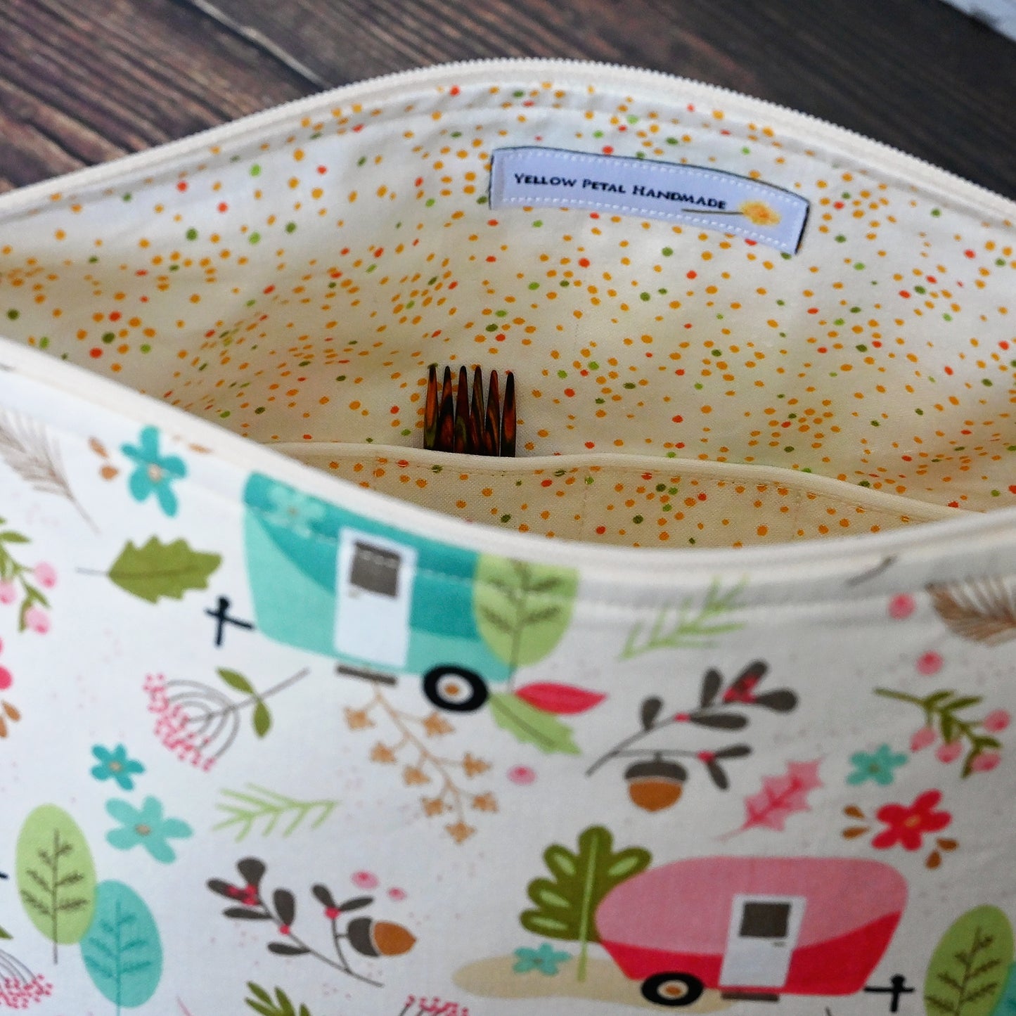 Cream and lime green camping themed project bag with a zipper closure and wrist strap. The interior has a fun spotty print and pockets for storage. Made in Nova Scotia, Canada by Yellow Petal Handmade.