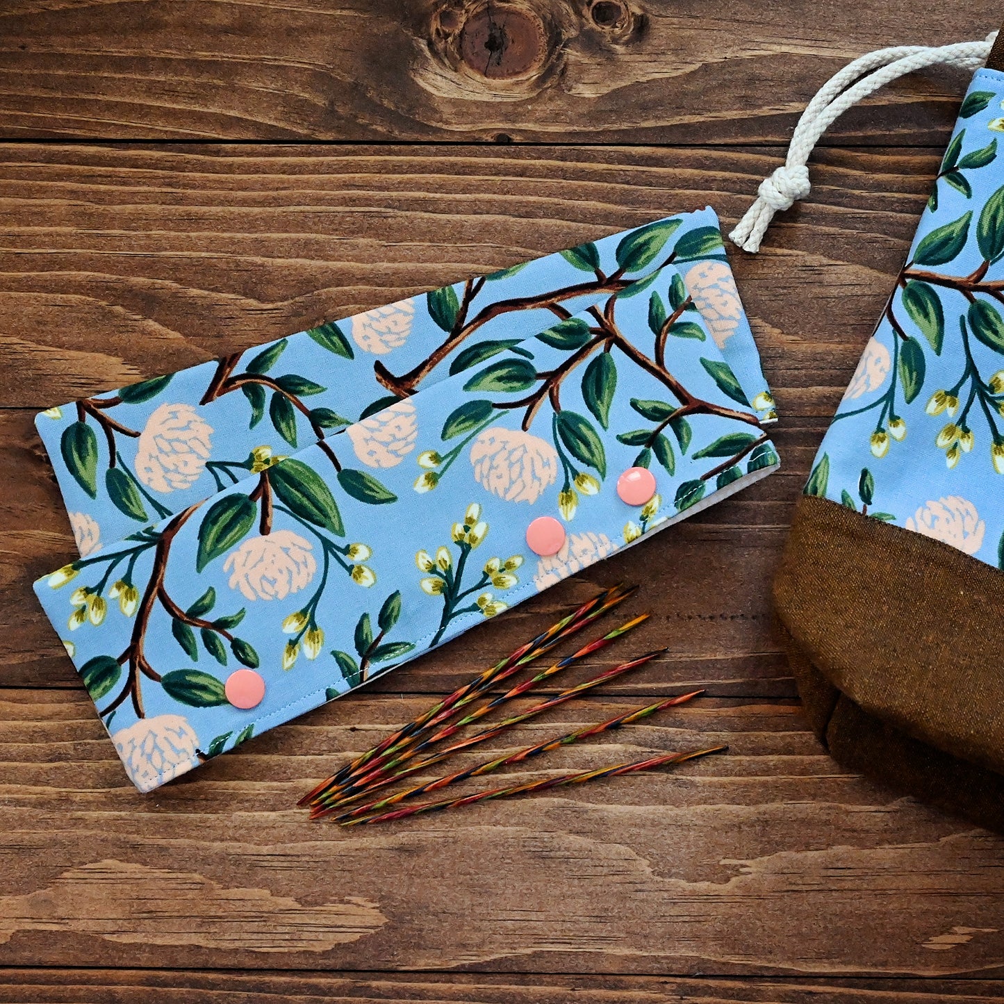 Pretty floral DPN cozies, perfect for keeping your projects on the needles! Crafted with a blue and peach floral from Rifle Paper Co, these close with snaps and hold your needles (and project) in place. Made in Canada by Yellow Petal Handmade.