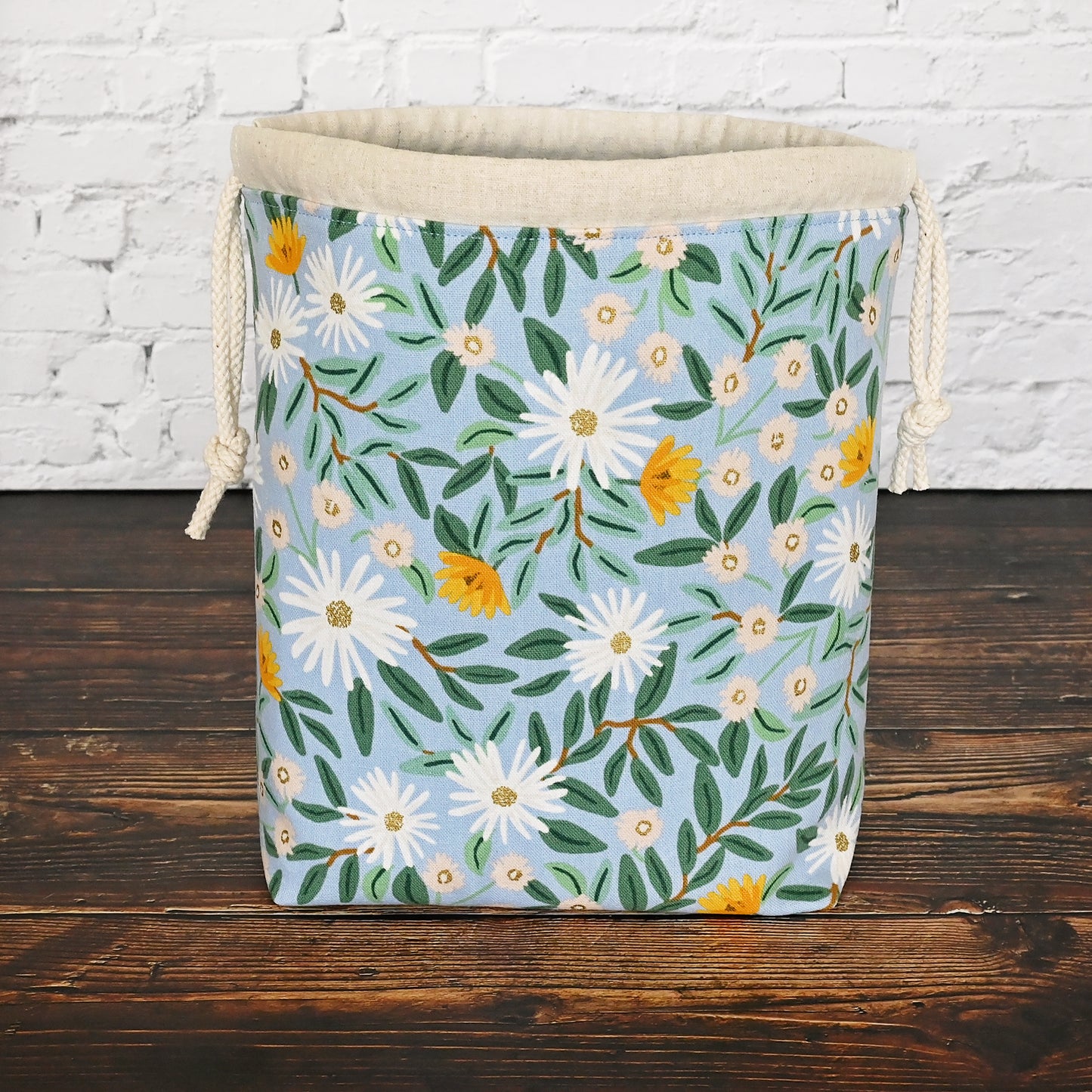 Pretty blue floral project bag made from a lovely canvas by Rifle Paper Co. Lined in a pretty aqua and closes securely with a double drawstring. Perfect for small knitting or crochet projects. Made in Canada by Yellow Petal Handmade.