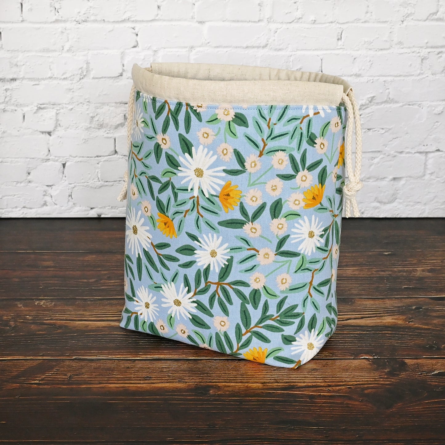 Pretty blue floral project bag made from a lovely canvas by Rifle Paper Co. Lined in a pretty aqua and closes securely with a double drawstring. Perfect for small knitting or crochet projects. Made in Canada by Yellow Petal Handmade.