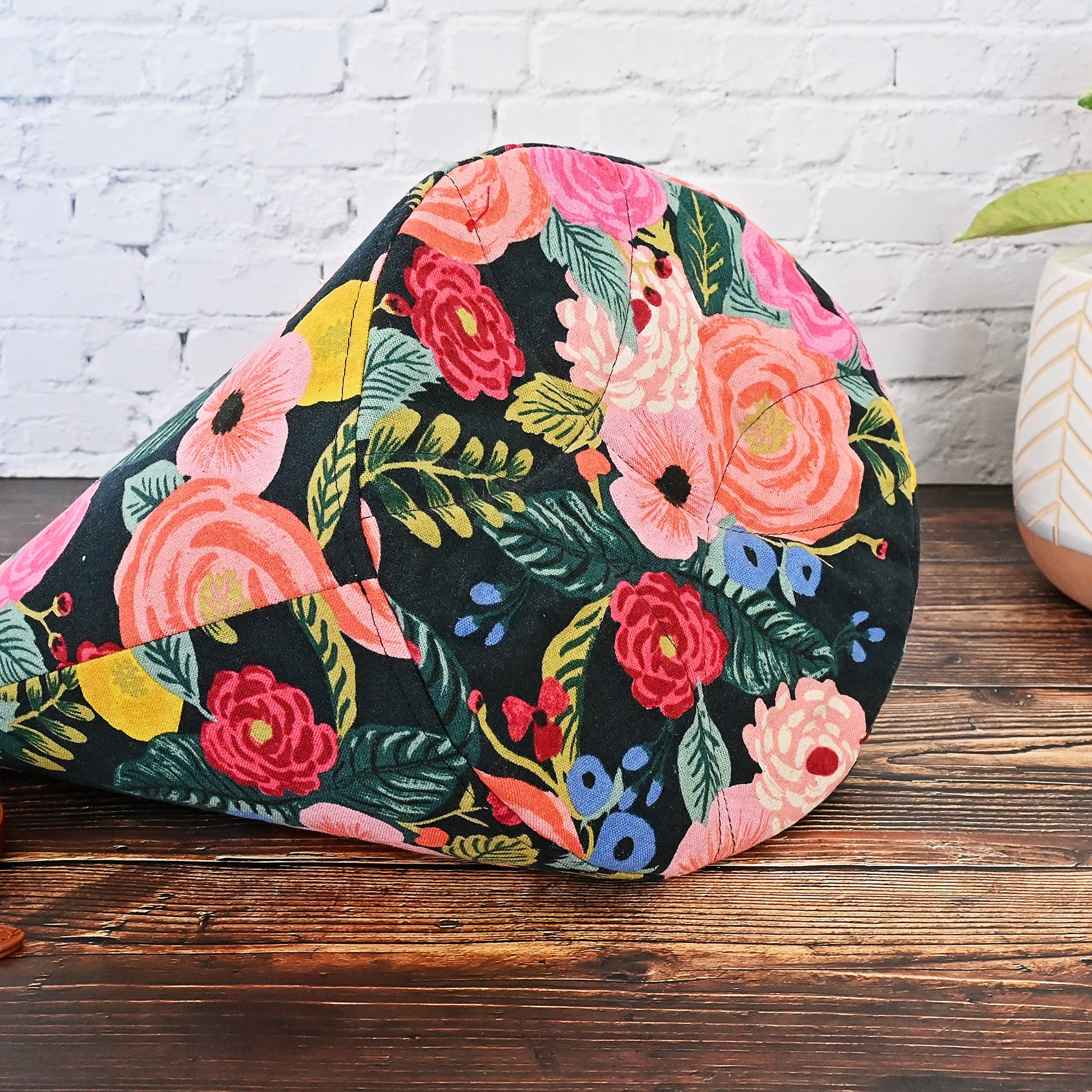 Beautiful canvas bucket bag for knitting or crochet projects.  Made from Rifle Paper Co's English Garden collection, this bag features a dark background with brightly colour flowers on the exterior.  The drawstring casing is made from a pretty burgundy linen and the bag is lined in a lovely dove coloured cotton with gold accents.  This bag features many interior pockets and folds down nicely while using for eacy access.