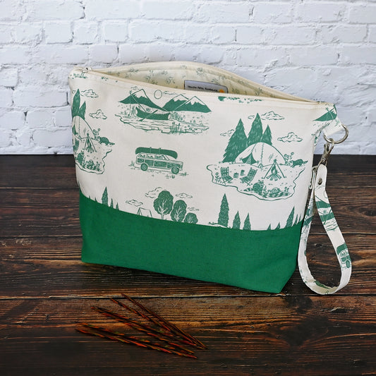 Classic Green and Cream project bag.  Made from a cream and green camping print and paired with a green linen on the exterior.  Lined in a pretty cream and green floral.  This bag comes with a removable wrist strap, and has multiple pockets for storage on the go.  Made in Canada by Yellow Petal Handmade.