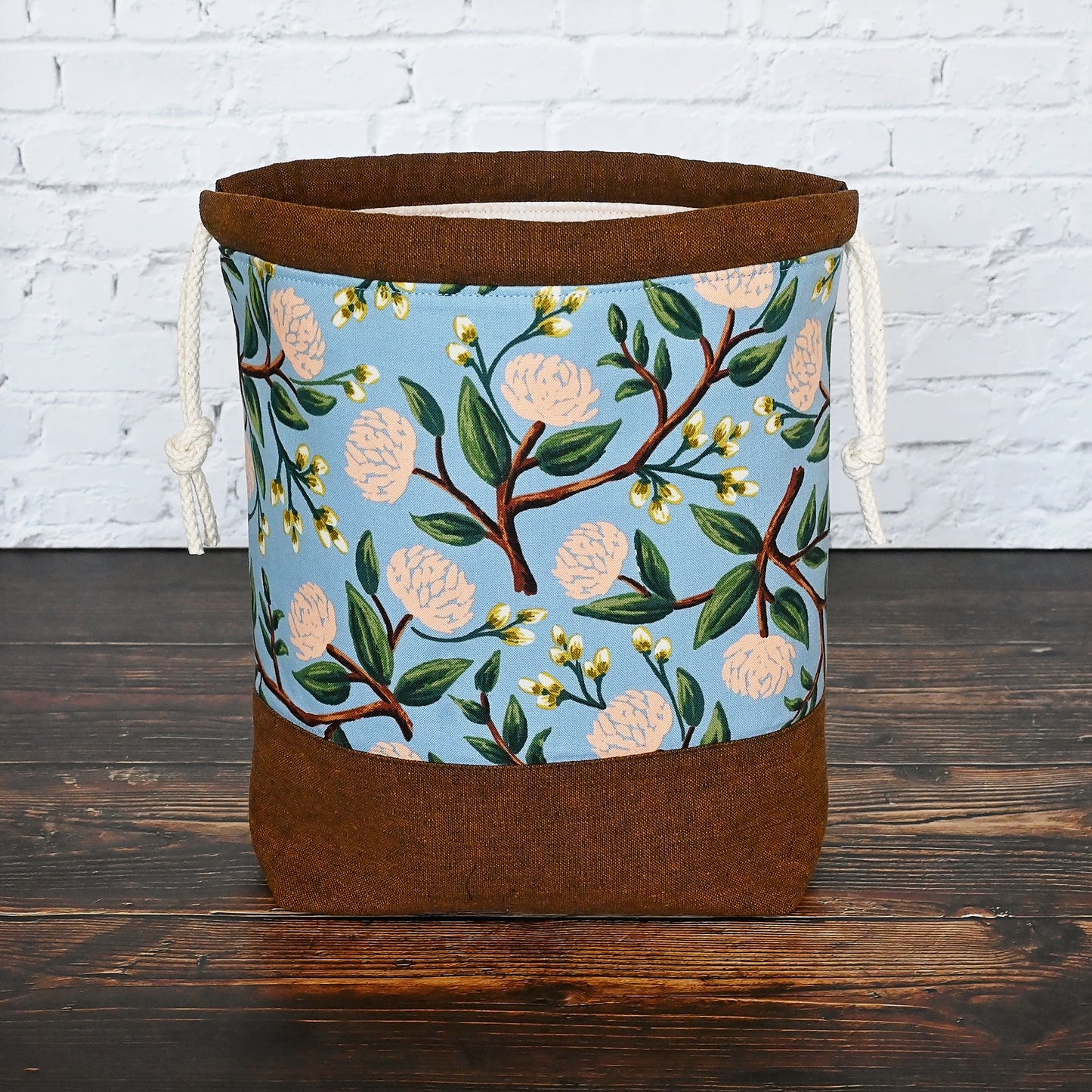 Pretty floral project bag in peonies fabric by Rifle Paper Co, paired with a lovely brown linen from Robert Kaufman. This bag is lined with a pale peach fabric and closes securely with a double drawstring. Made in Canada by Yellow Petal Handmade.