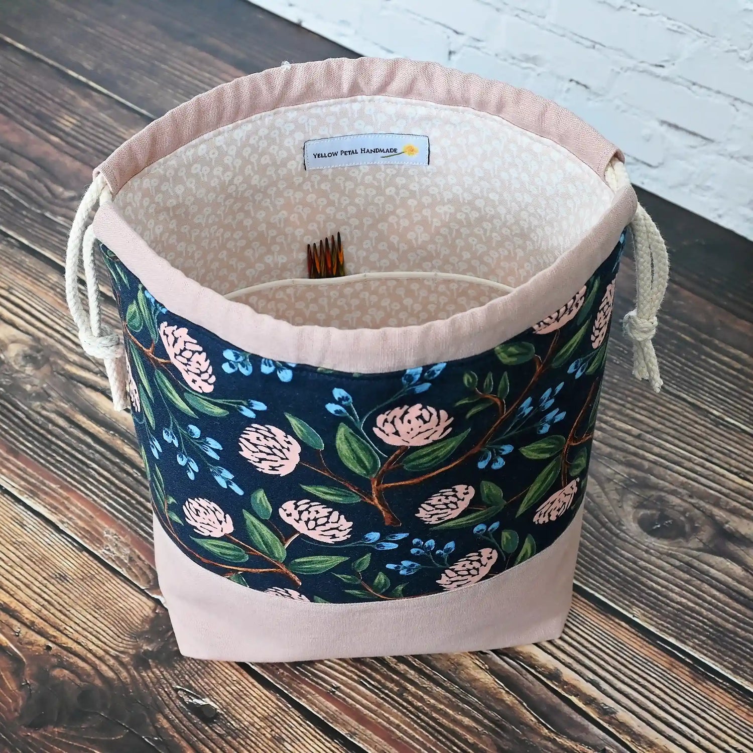 Pretty drawstring project bag made from a navy cotton with pink peonies and paired with a matching pink linen bottom.  Available with or without pockets.  Made by Yellow Petal Handmade in Nova Scotia, Canada.