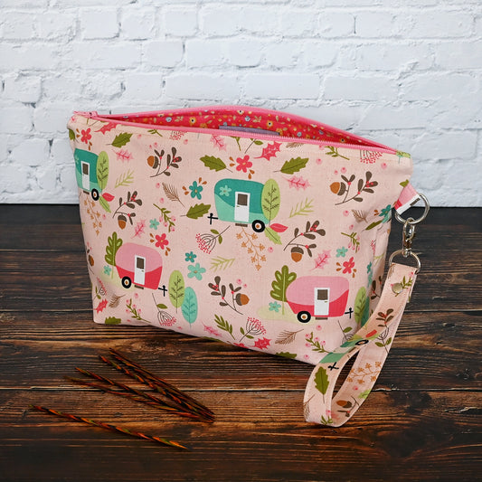 Pretty pink camper themed pouch with removable wrist strap.  This pouch doesn't have pockets, but is lined in a lively coordinating floral.  Made in Canada by Yellow Petal Handmade.