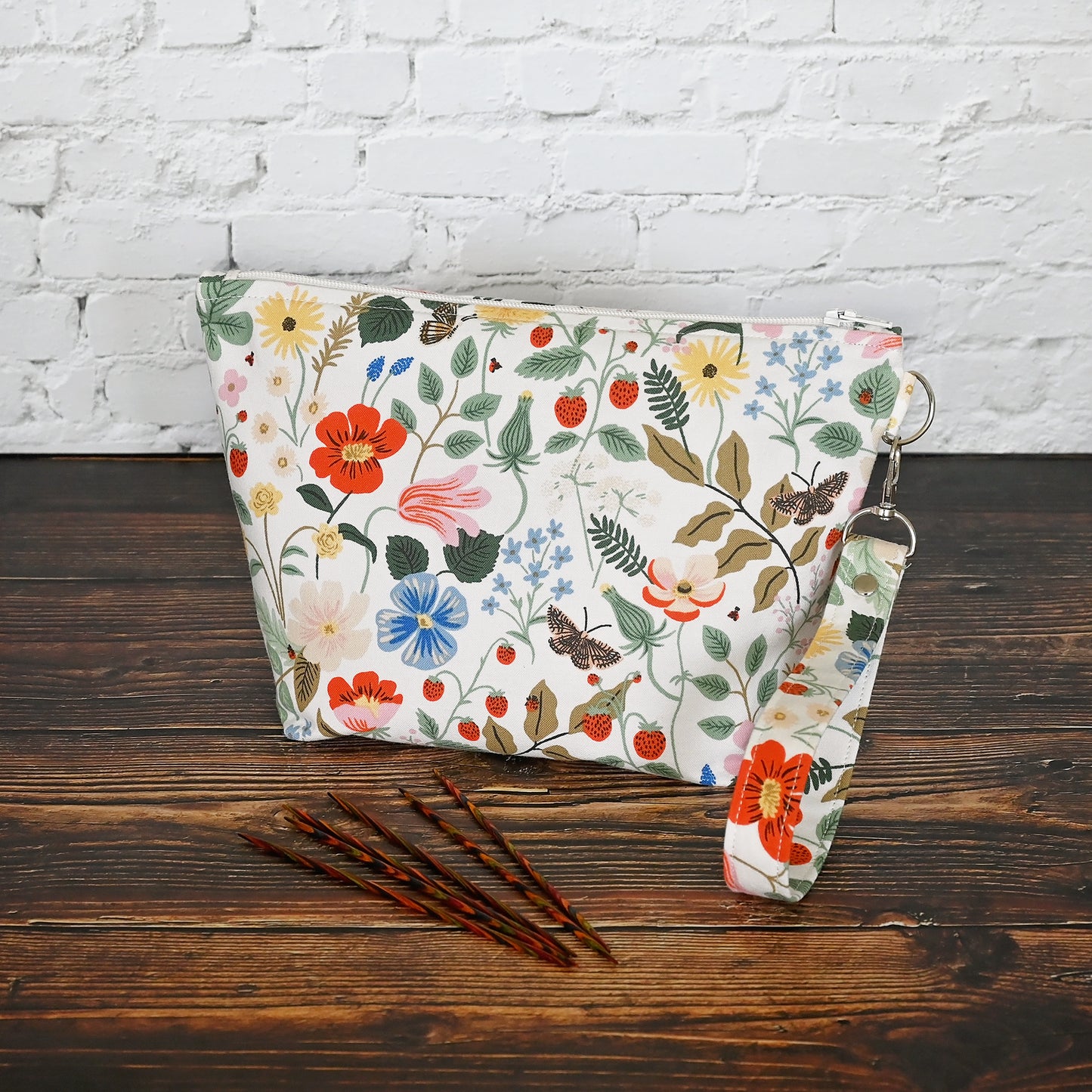 Pretty floral pouches in Rifle Paper Co's Strawberry Fields fabric. Lined with a pretty pink and white floral lining. These bags come with a removable wrist strap and a perfect for carrying small projects.