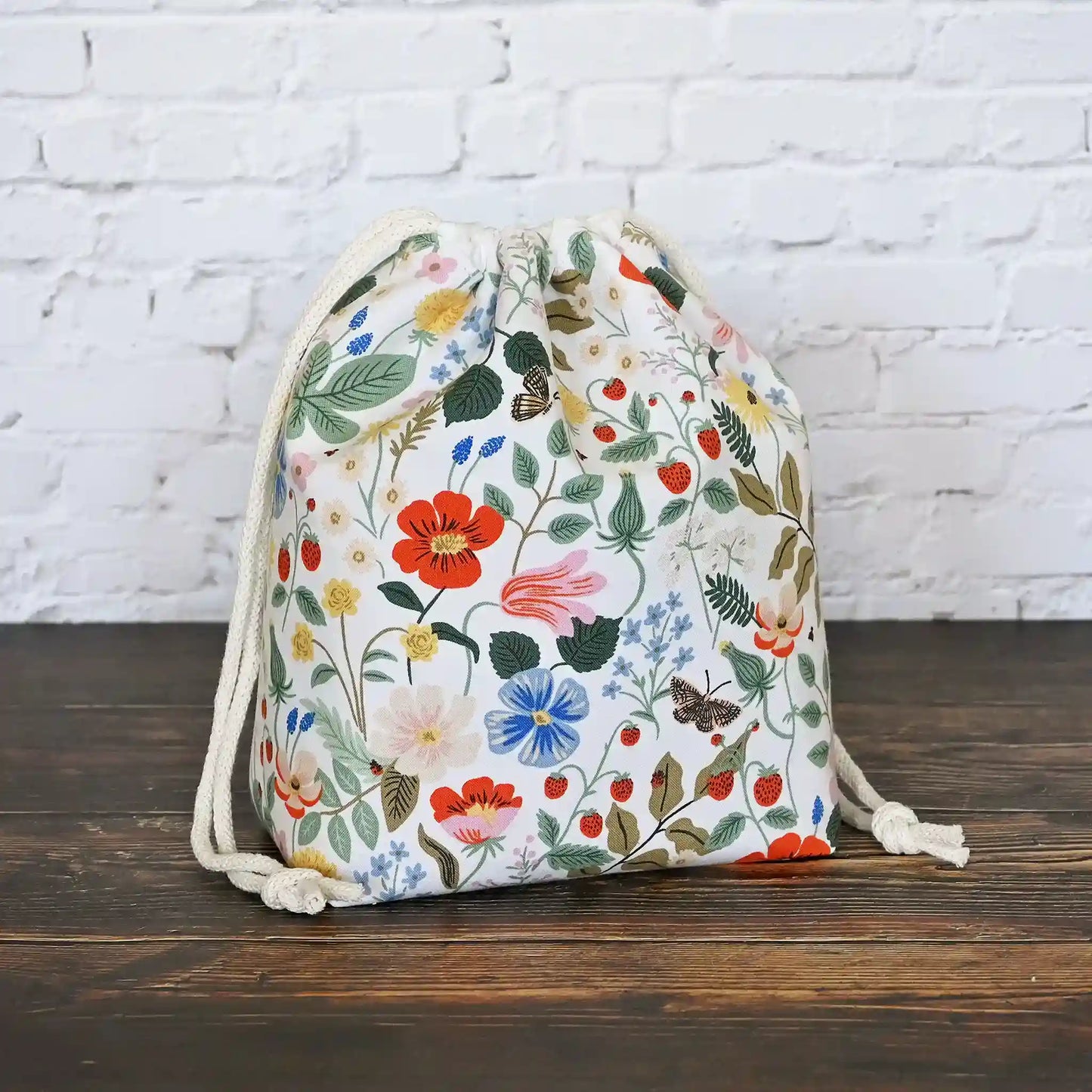 Small drawstring knitting bag with pockets. Made from Rifle Paper Co Strawberry Fields Fabric. Made in Nova Scotia, Canada by Yellow Petal Handmade.