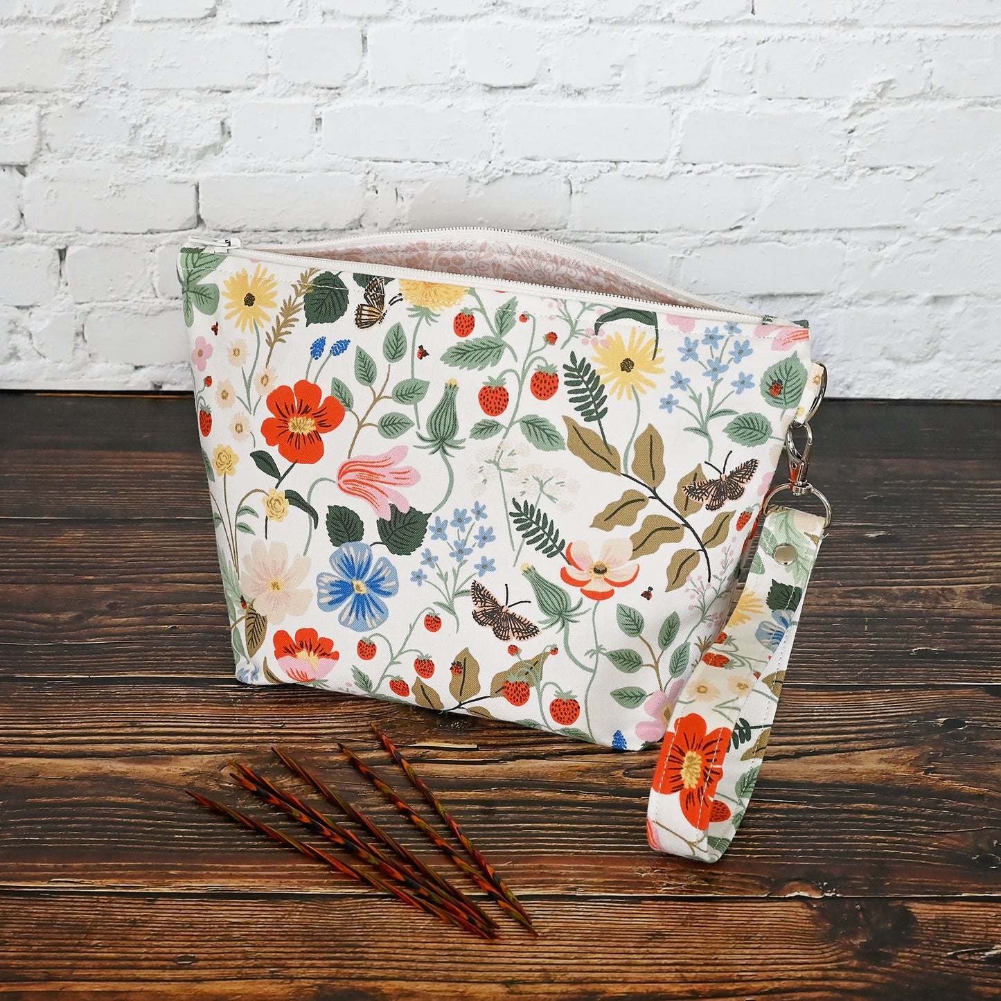 Pretty floral pouches in Rifle Paper Co's Strawberry Fields fabric. Lined with a pretty pink and white floral lining. These bags come with a removable wrist strap and a perfect for carrying small projects.