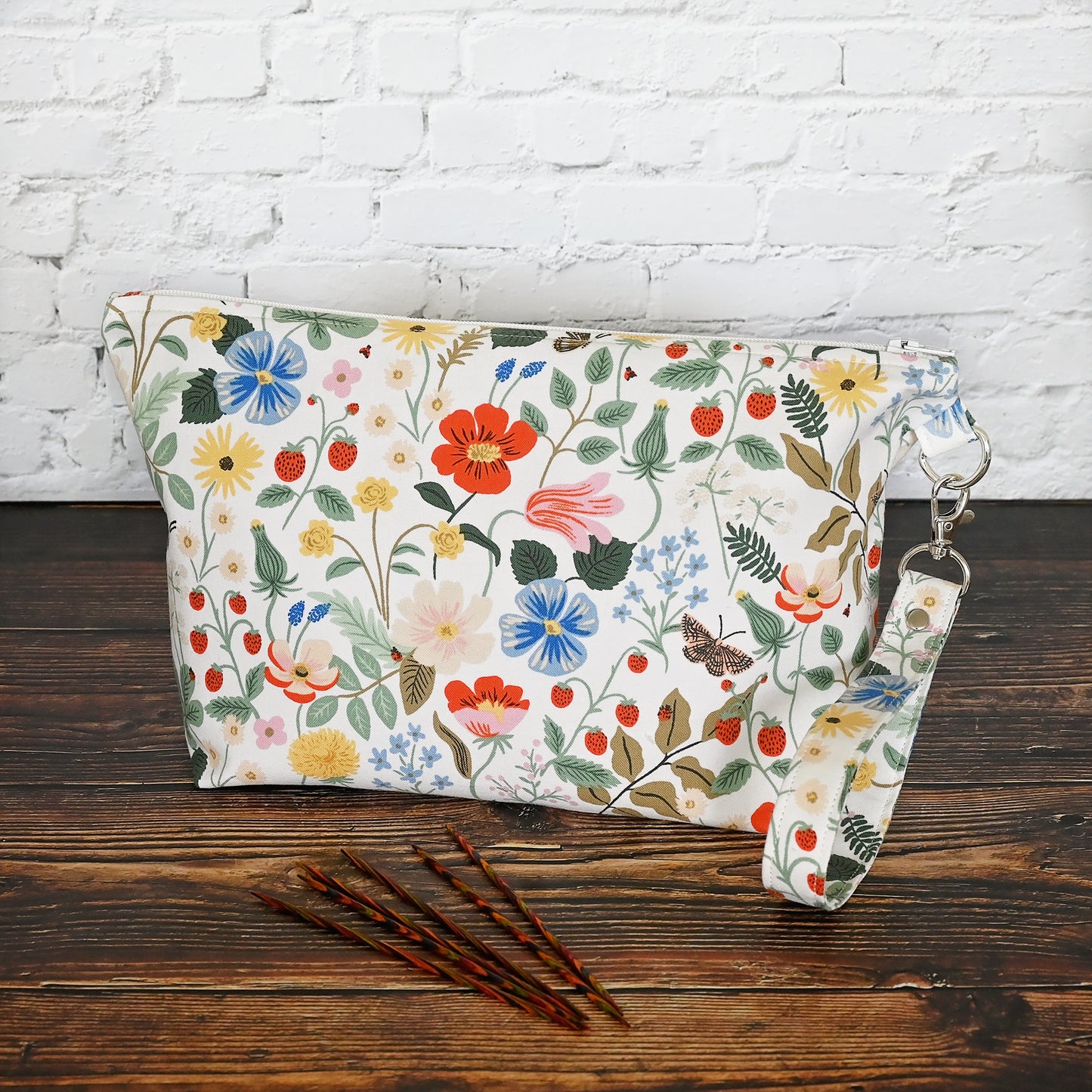 Pretty floral pouches in Rifle Paper Co's Strawberry Fields fabric. Lined with a pretty pink and white floral lining. These bags come with a removable wrist strap and a perfect for carrying small projects.