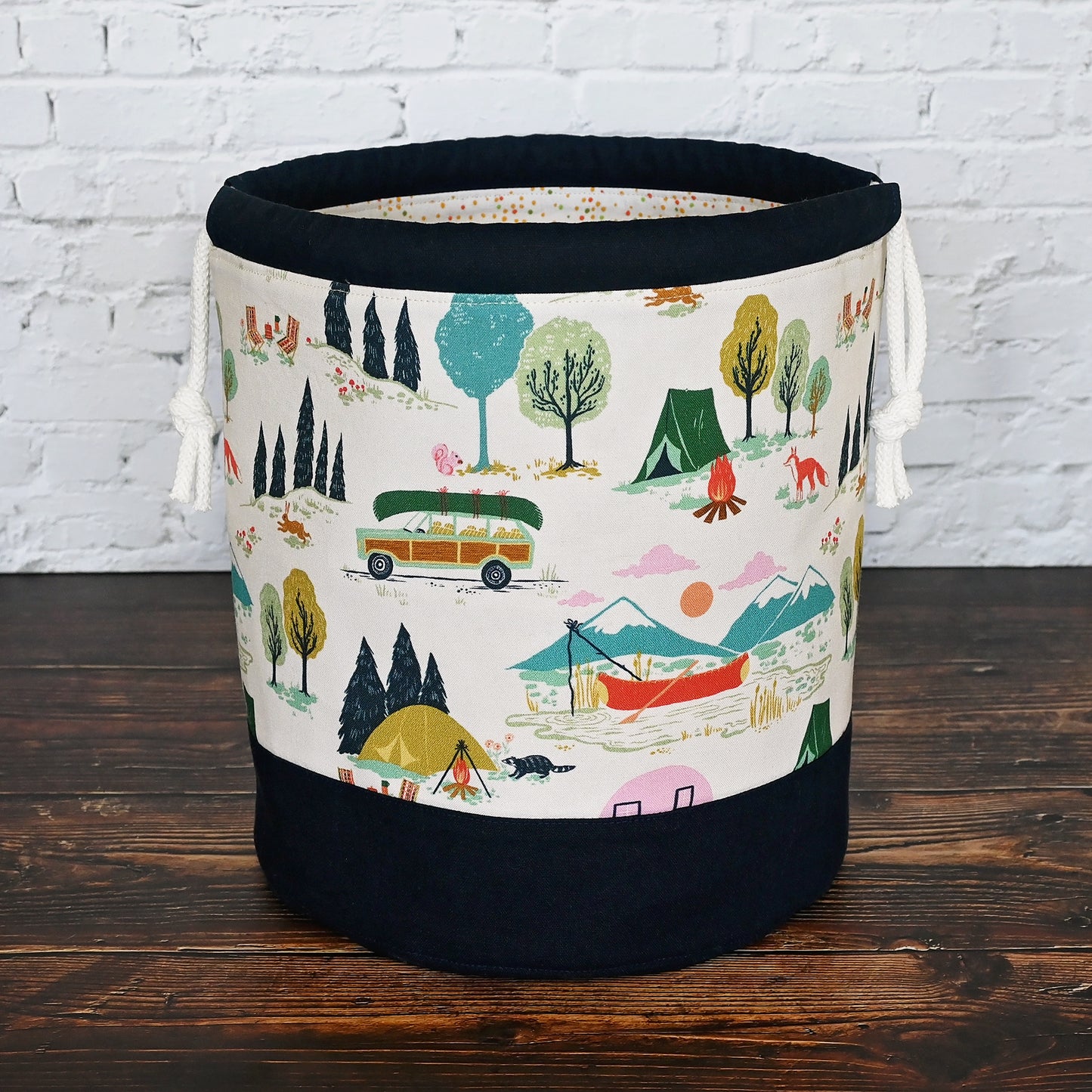 Fun vintage inspired drawstring bucket bag with lots of pockets. Perfect for knitting or crochet projects. Made from a fun camper and vintage car themed cream cotton and paired with a navy linen. Made in Canada by Yellow Petal Handmade.