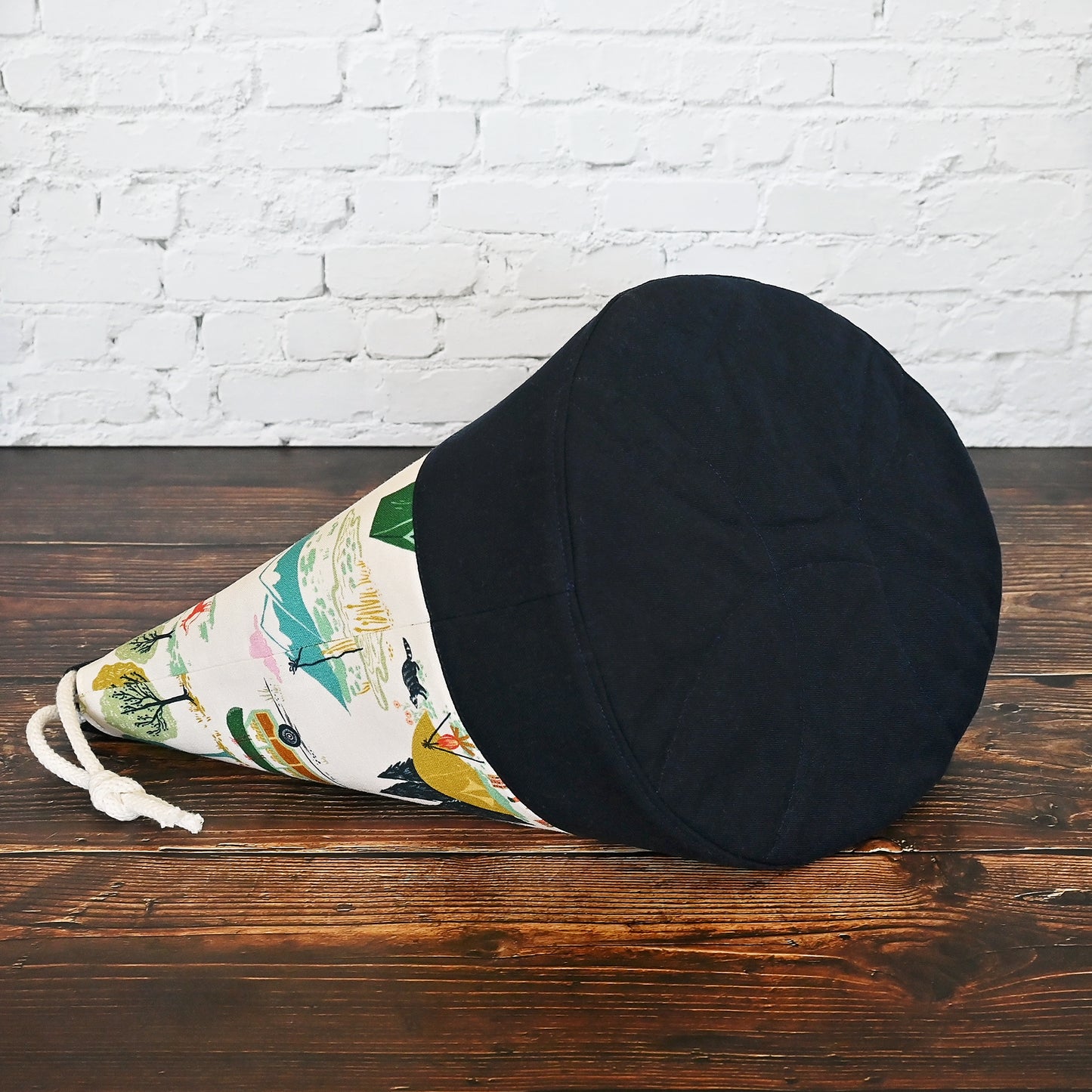 Fun vintage inspired drawstring bucket bag with lots of pockets. Perfect for knitting or crochet projects. Made from a fun camper and vintage car themed cream cotton and paired with a navy linen. Made in Canada by Yellow Petal Handmade.