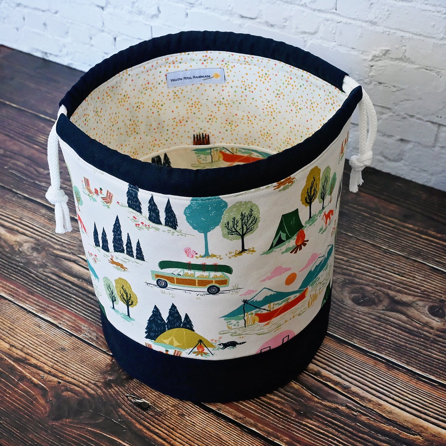 Fun vintage inspired drawstring bucket bag with lots of pockets. Perfect for knitting or crochet projects. Made from a fun camper and vintage car themed cream cotton and paired with a navy linen. Made in Canada by Yellow Petal Handmade.