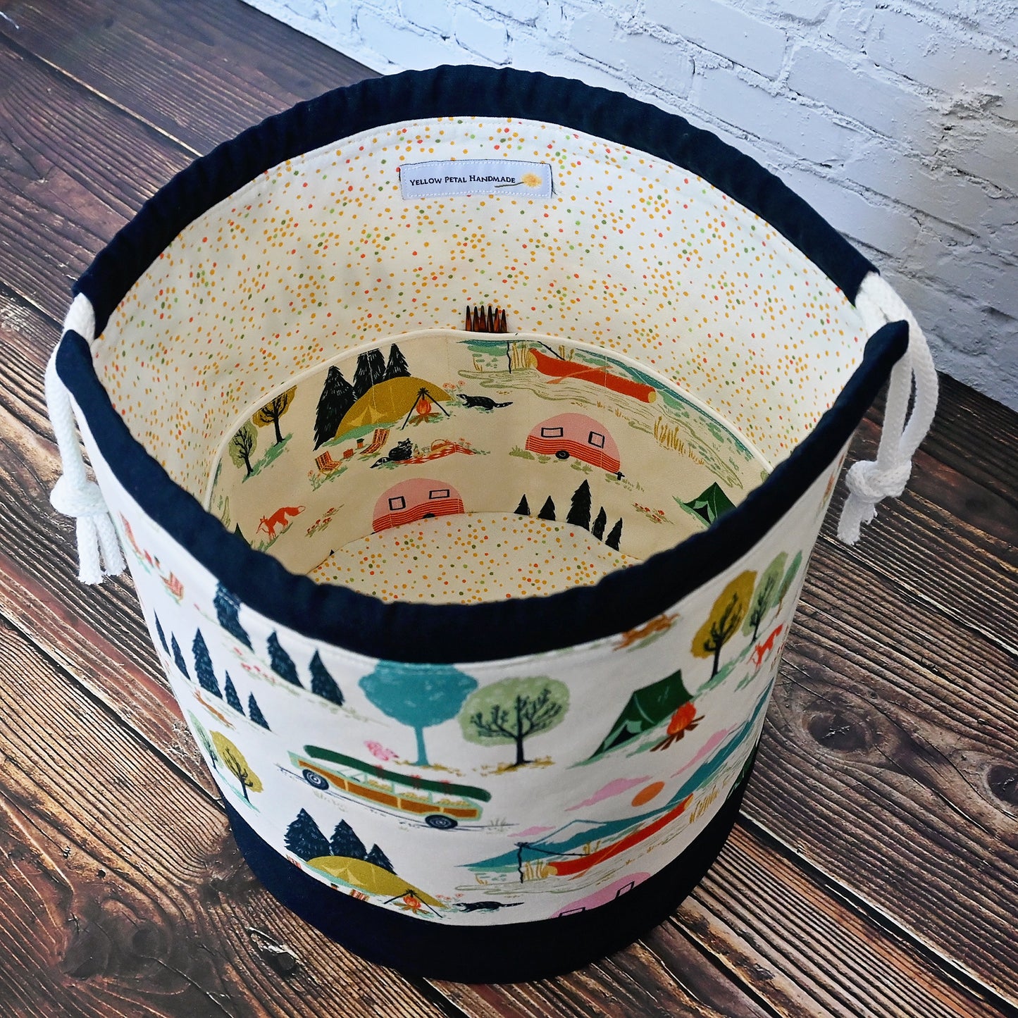 Fun vintage inspired drawstring bucket bag with lots of pockets. Perfect for knitting or crochet projects. Made from a fun camper and vintage car themed cream cotton and paired with a navy linen. Made in Canada by Yellow Petal Handmade.