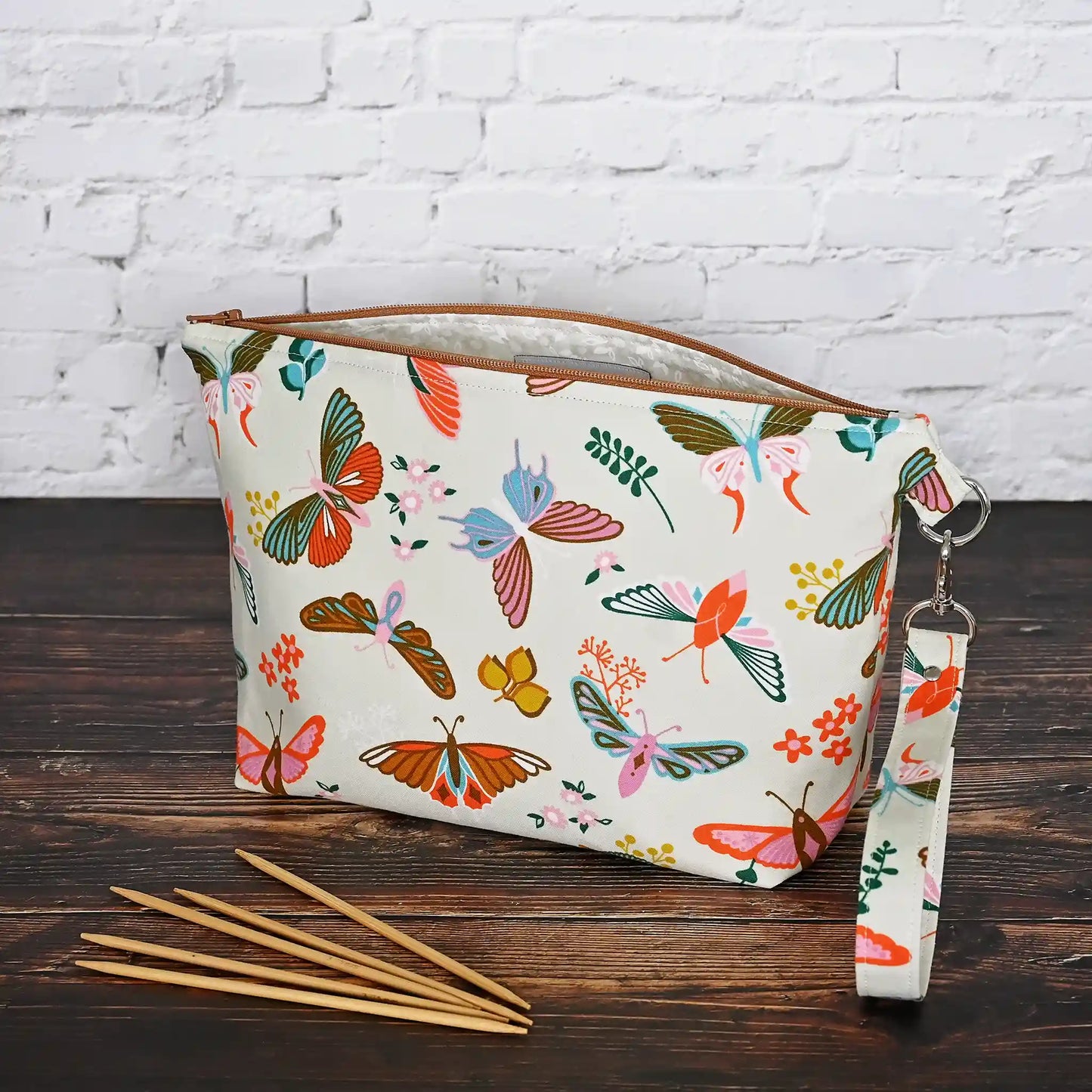Gorgeous cream pouch with removable strap. Made from a striking butterfly patterned cotton and lined in a pretty cream floral, both by Ruby Star Society. Made in Canada by Yellow Petal Handmade.