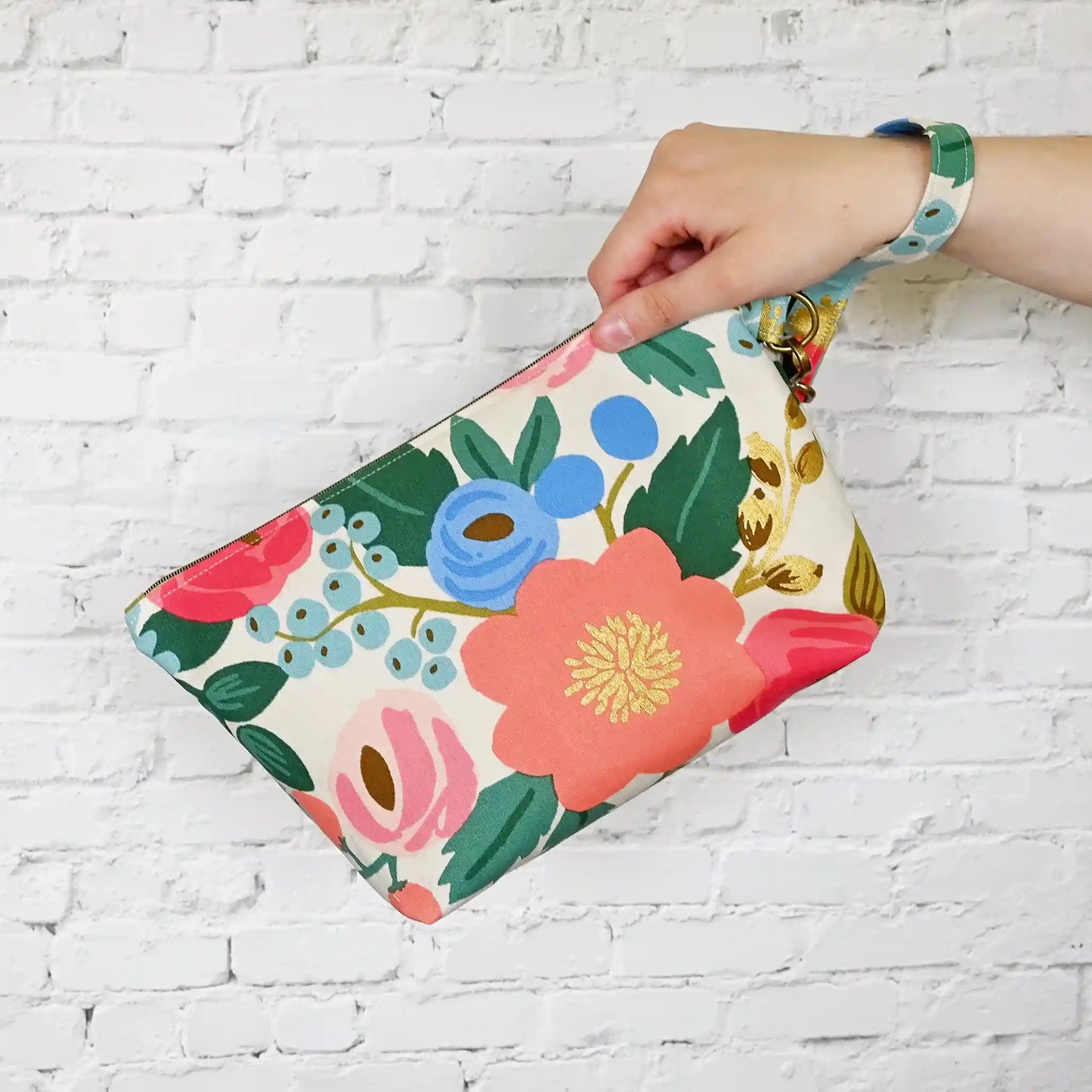 Cream floral canvas zippered pouch with removable wrist strap. Made from Rifle Paper Co's Antique Garden. Handmade in Nova Scotia, Canada.