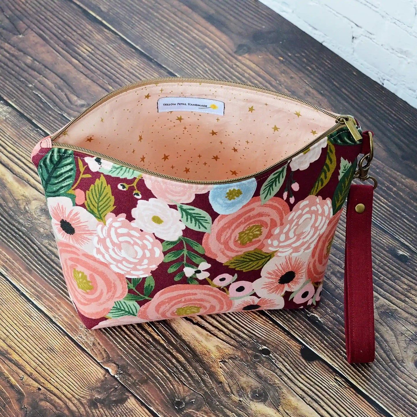 Burgundy floral canvas pouch with blush and metallic gold star lining. Made in Canada by Yellow Petal Handmade.