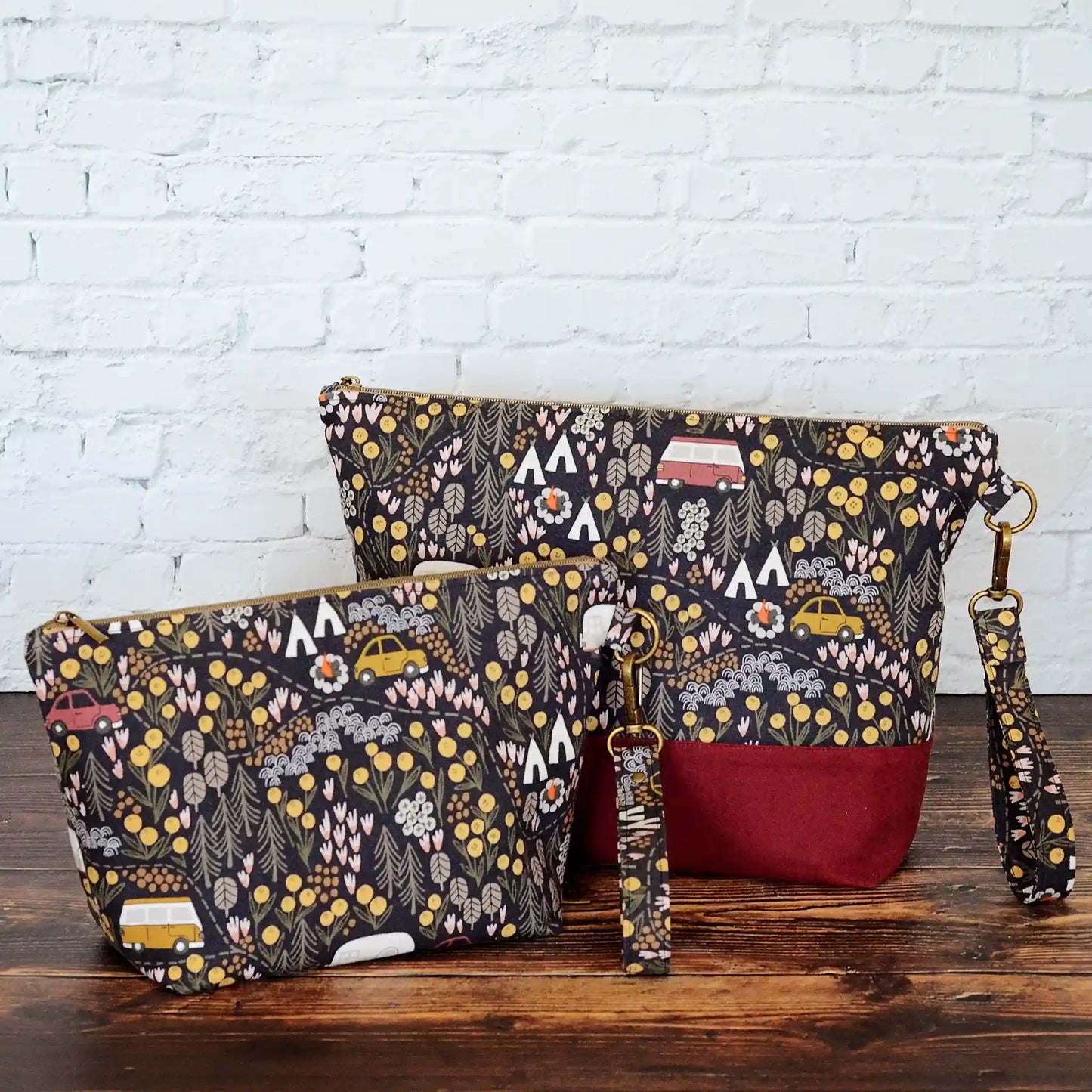 Camping themed project bag with pockets. Made from a black camping fabric with a burgundy linen. Made in Nova Scotia, Canada.