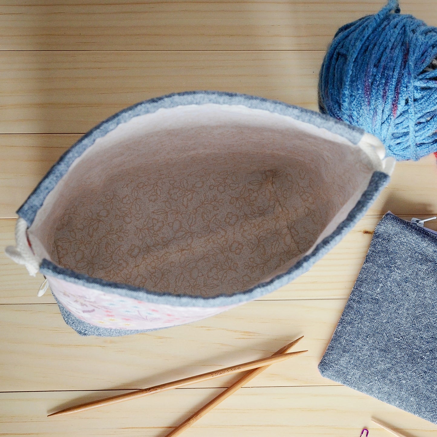 Mauve floral and indigo linen knitting project bag and pouch set with beige floral lining. Made in Nova Scotia, Canada by Yellow Petal Handmade.