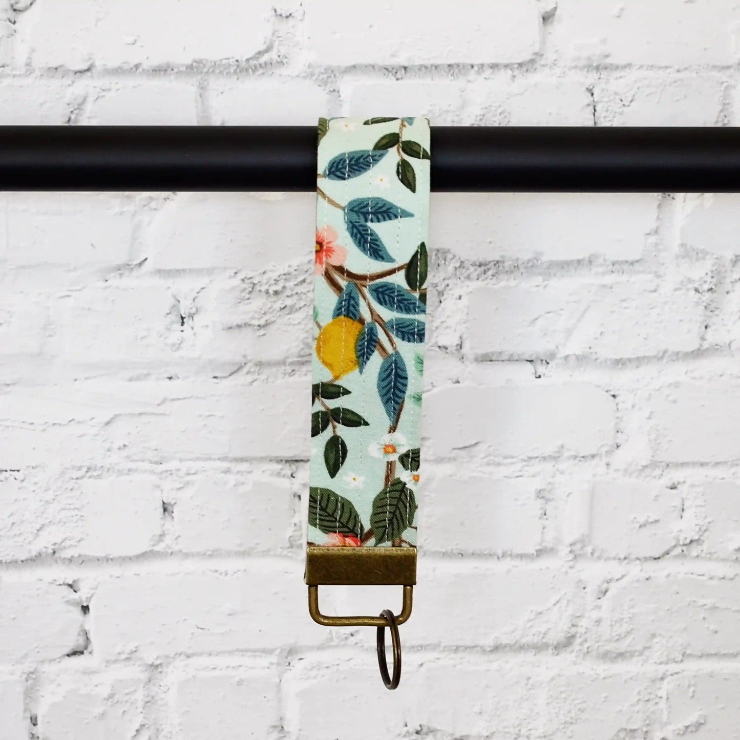 Pretty aqua wristlet keychain made from the Bramble collection by Rifle Paper Co. Made in Canada.