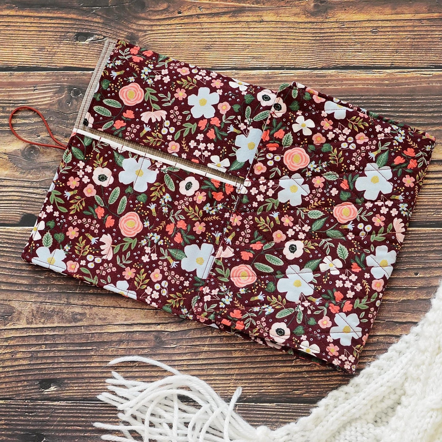 Quilted crochet hook wrap in burgundy floral Rifle Paper Co fabric. Made in Canada by Yellow Petal Handmade.