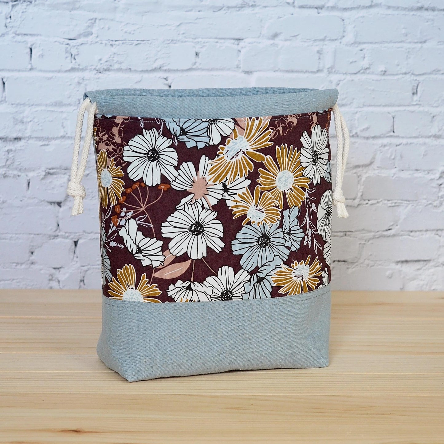 Small floral project bag for knitting or crochet in blues and browns. Made in Nova Scotia, Canada.
