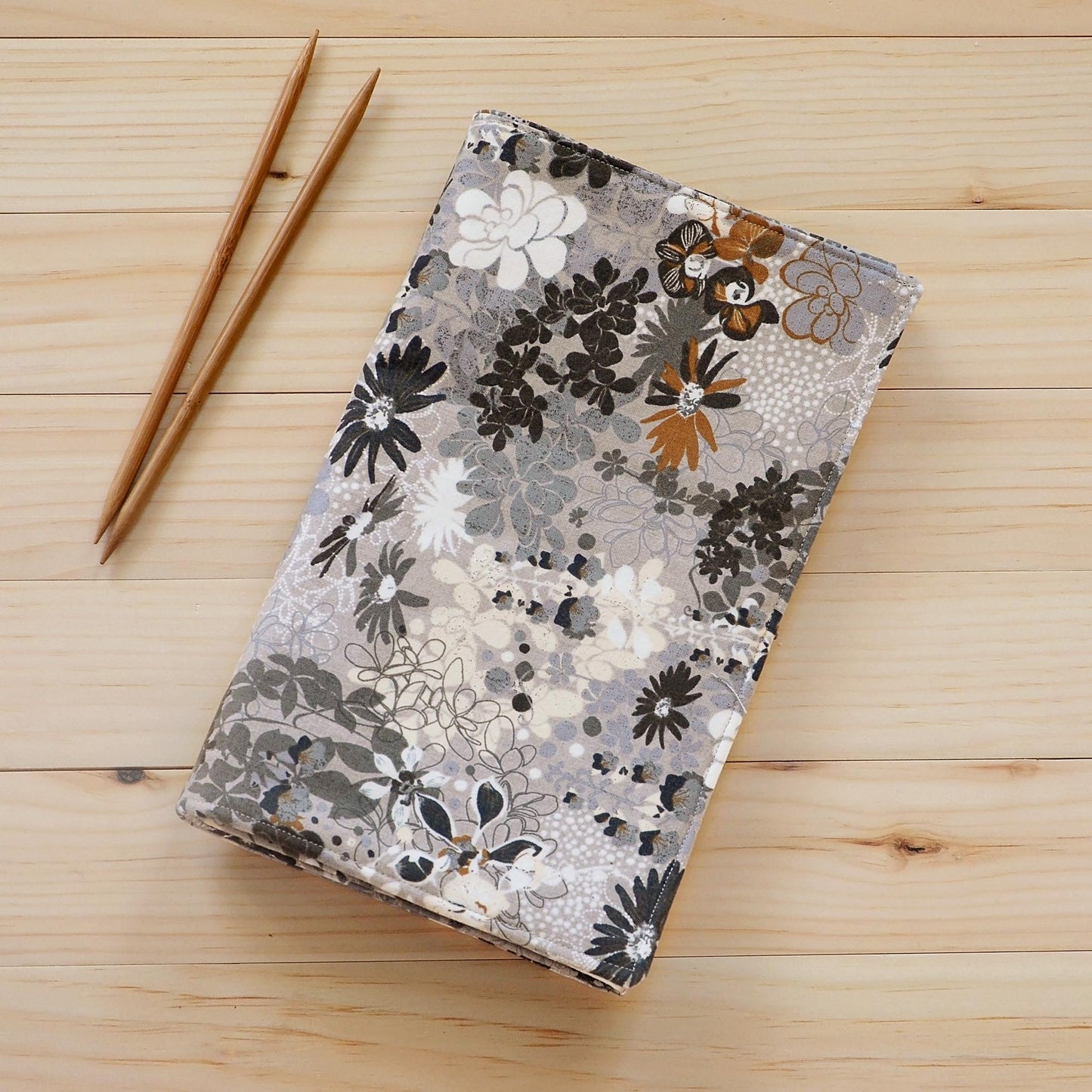 Large knitting needle tri-fold wrap in grey floral with bronze accents. Made by Yellow Petal Handmade in Nova Scotia, Canada.