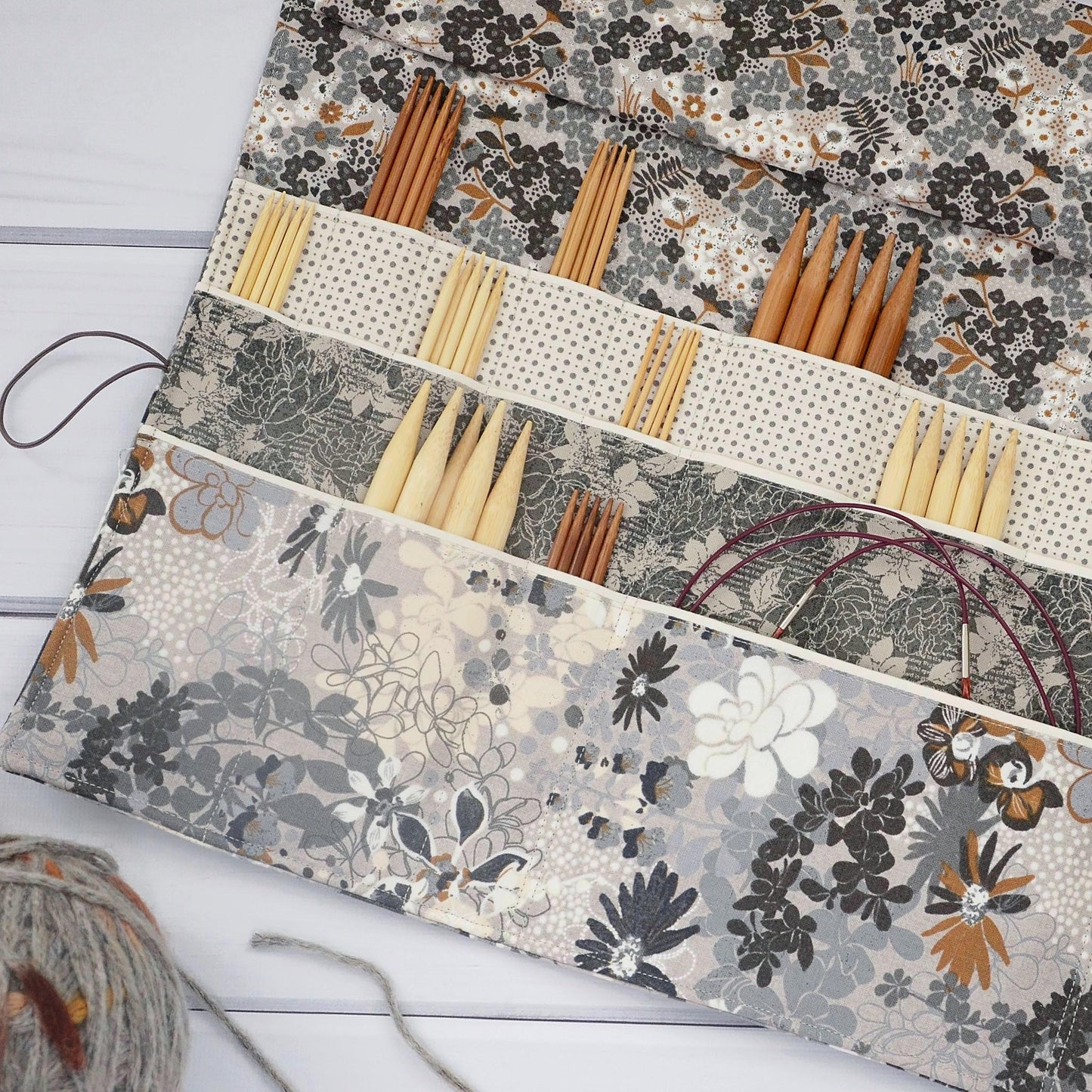 Large knitting needle tri-fold wrap in grey floral with bronze accents. Made by Yellow Petal Handmade in Nova Scotia, Canada.