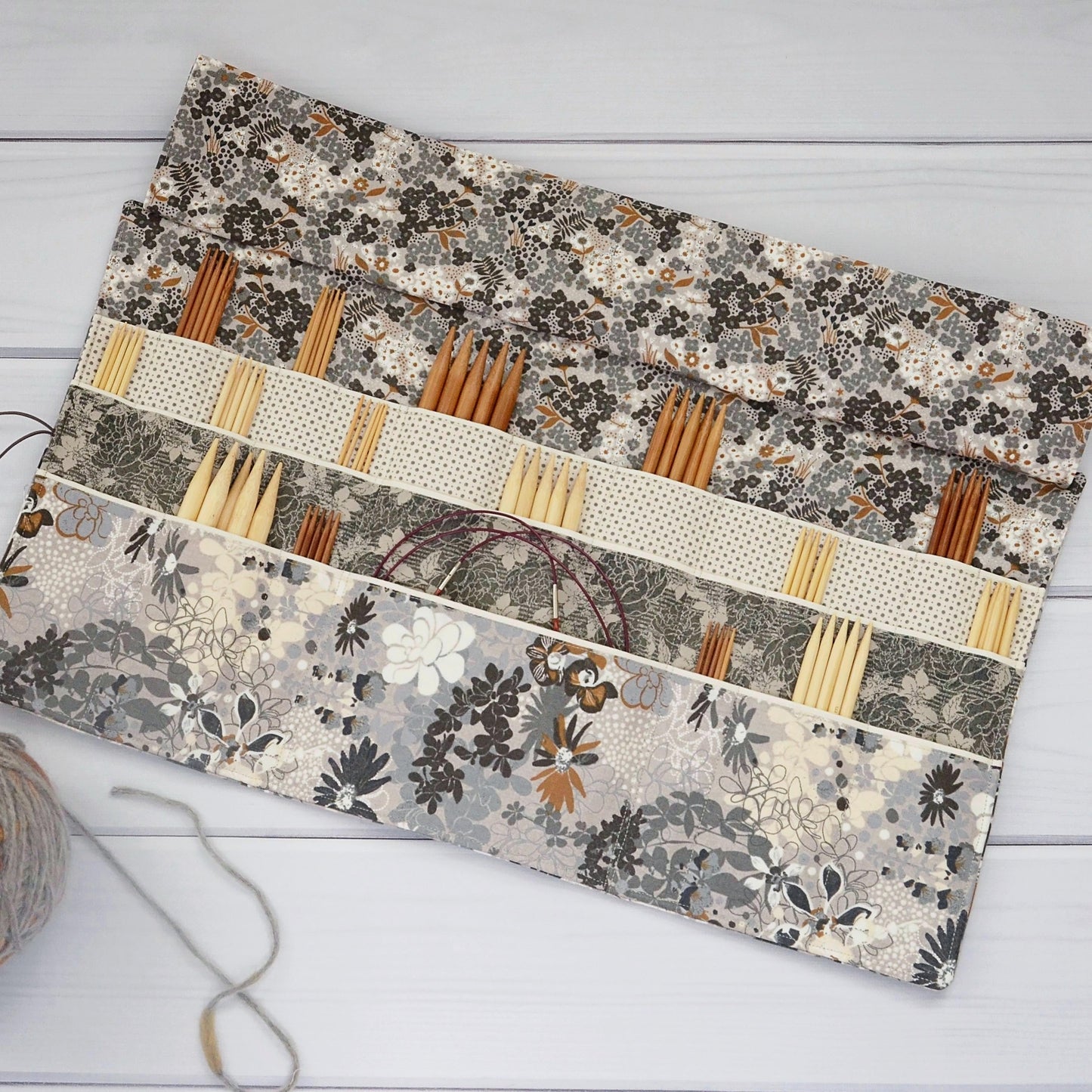 Large knitting needle tri-fold wrap in grey floral with bronze accents. Made by Yellow Petal Handmade in Nova Scotia, Canada.