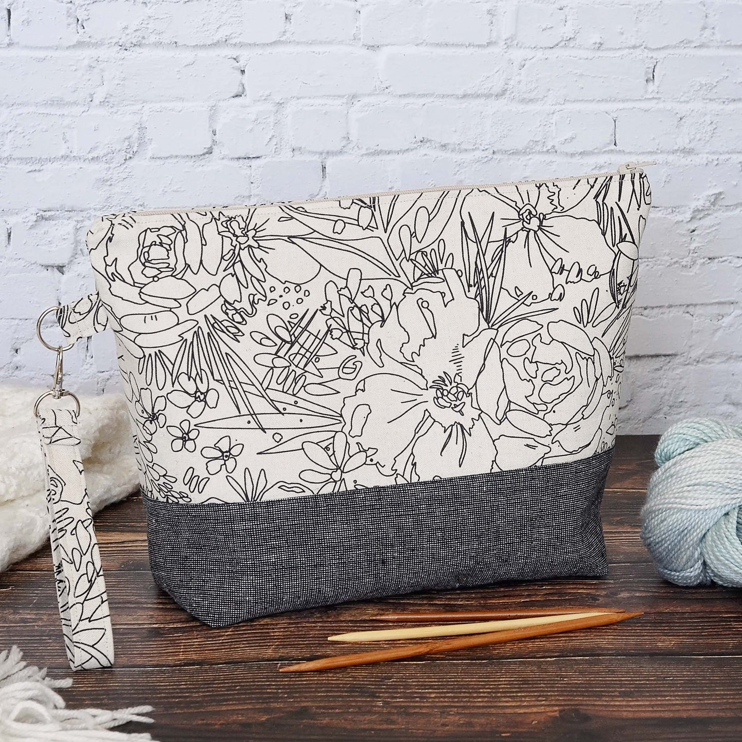 Classic linen zippered project bag for knitting or crochet. Black and beige linens and features a wrist strap. Made in Nova Scotia, Canada by Yellow Petal Handmade.