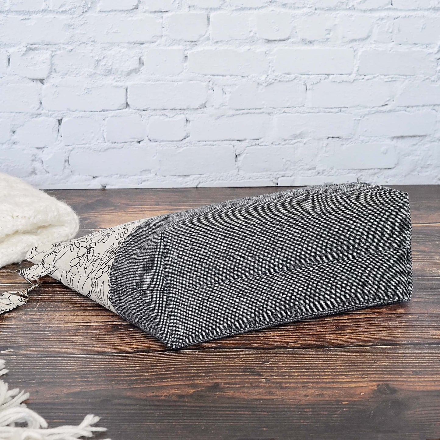 Classic linen zippered project bag for knitting or crochet. Black and beige linens and features a wrist strap. Made in Nova Scotia, Canada by Yellow Petal Handmade.