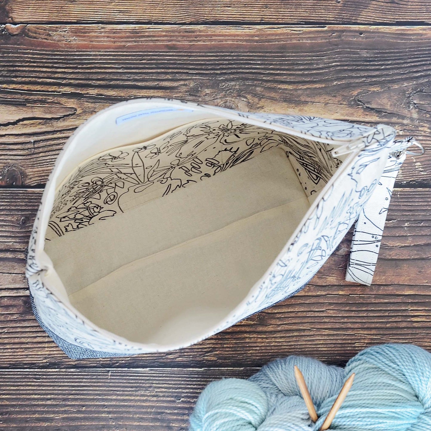 Classic linen zippered project bag for knitting or crochet. Black and beige linens and features a wrist strap. Made in Nova Scotia, Canada by Yellow Petal Handmade.