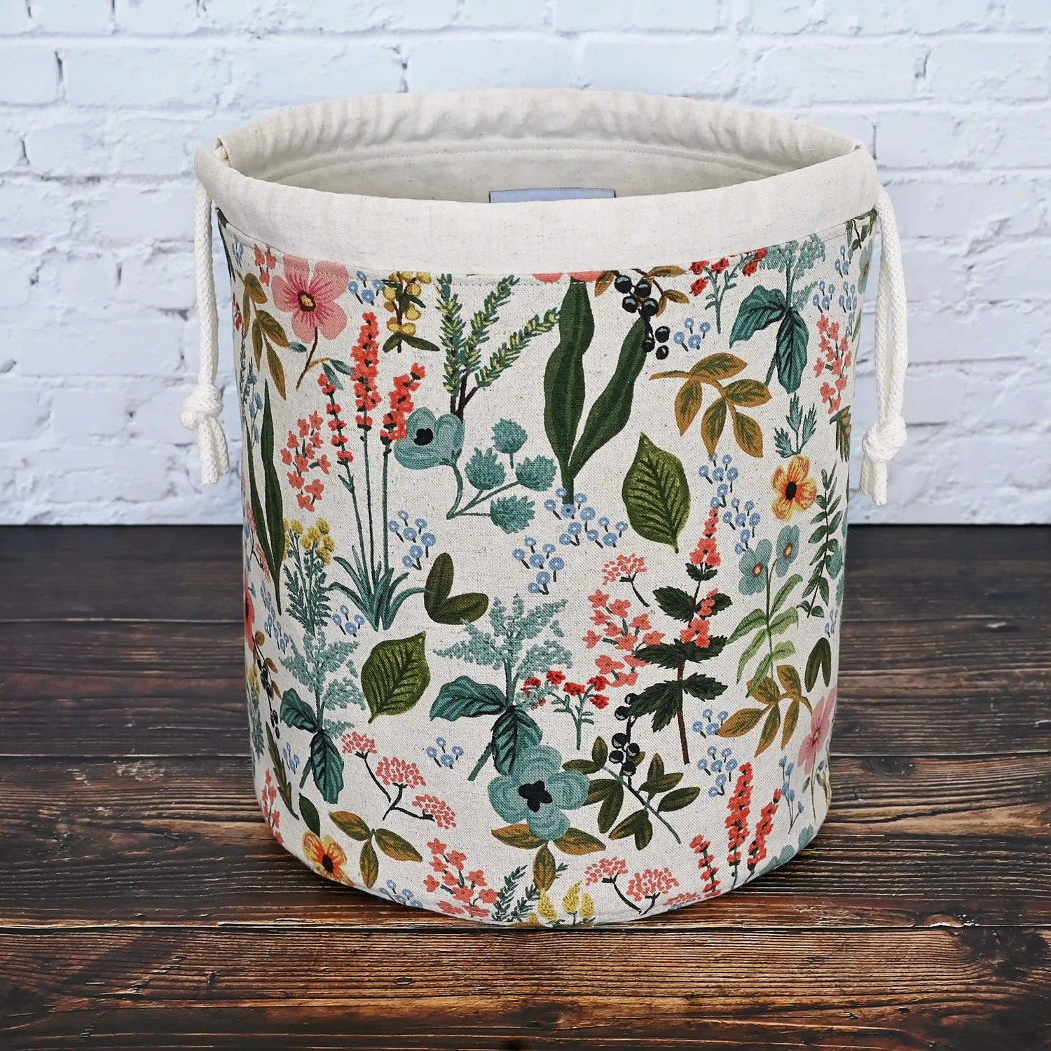 Canvas bucket bag in a beautiful floral canvas by Rifle Paper Co.  Lined in an unbleached cotton and features lots of pockets in a pretty aqua cotton.  This bag closes with a drawstring and has a quilted bottom for stability.  Made in Canada by Yellow Petal Handmade.