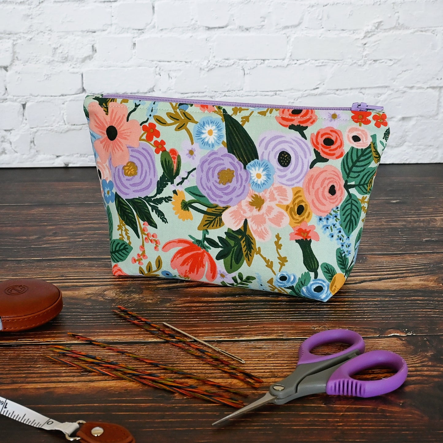 Aqua Floral accessory pouch in Rifle Paper's Garden Party fabric.  Lined in a pretty pale pink spotty fabric and closes with a lavendar zipper.  Made in Canada by Yellow Petal Handmade.