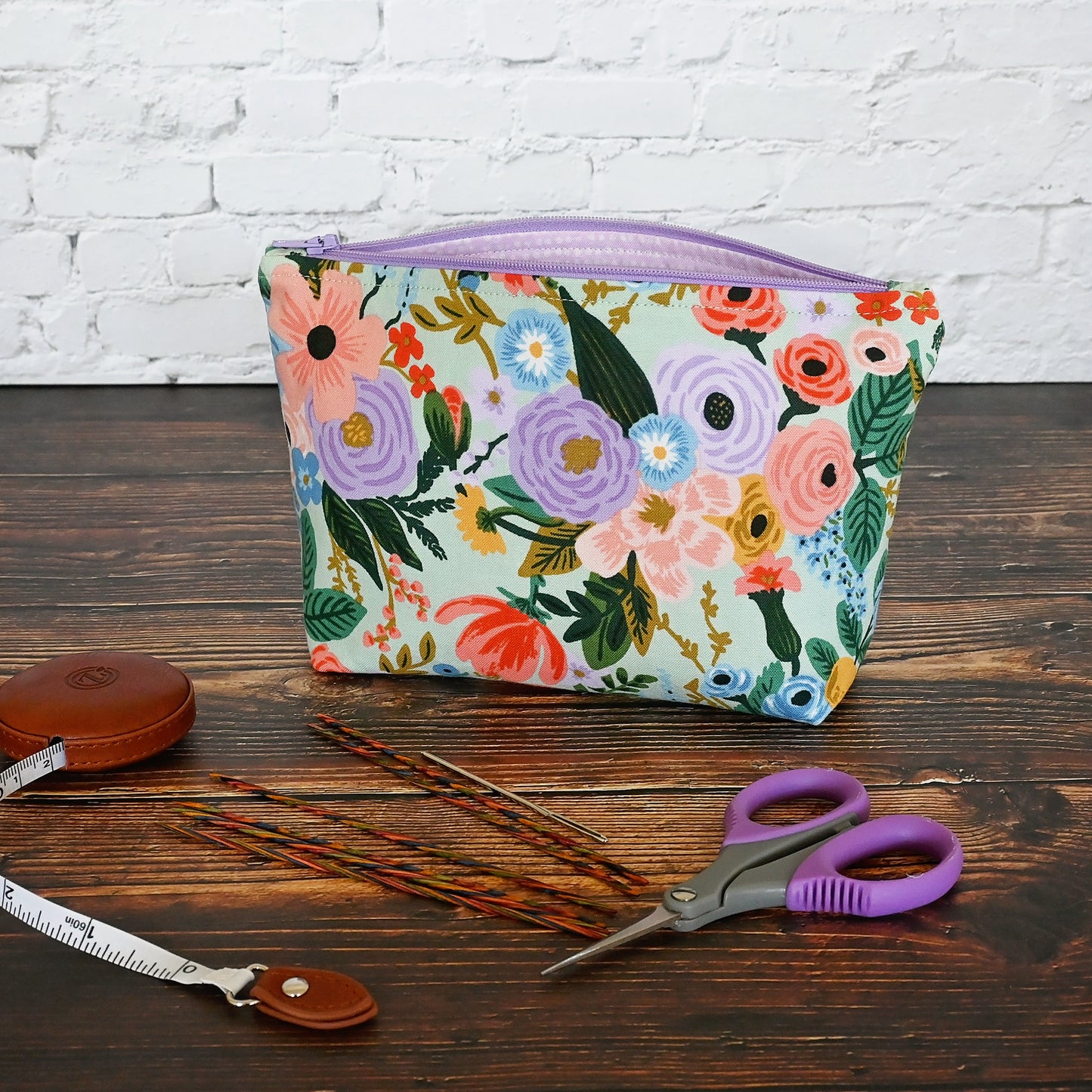 Aqua Floral accessory pouch in Rifle Paper's Garden Party fabric.  Lined in a pretty pale pink spotty fabric and closes with a lavendar zipper.  Made in Canada by Yellow Petal Handmade.