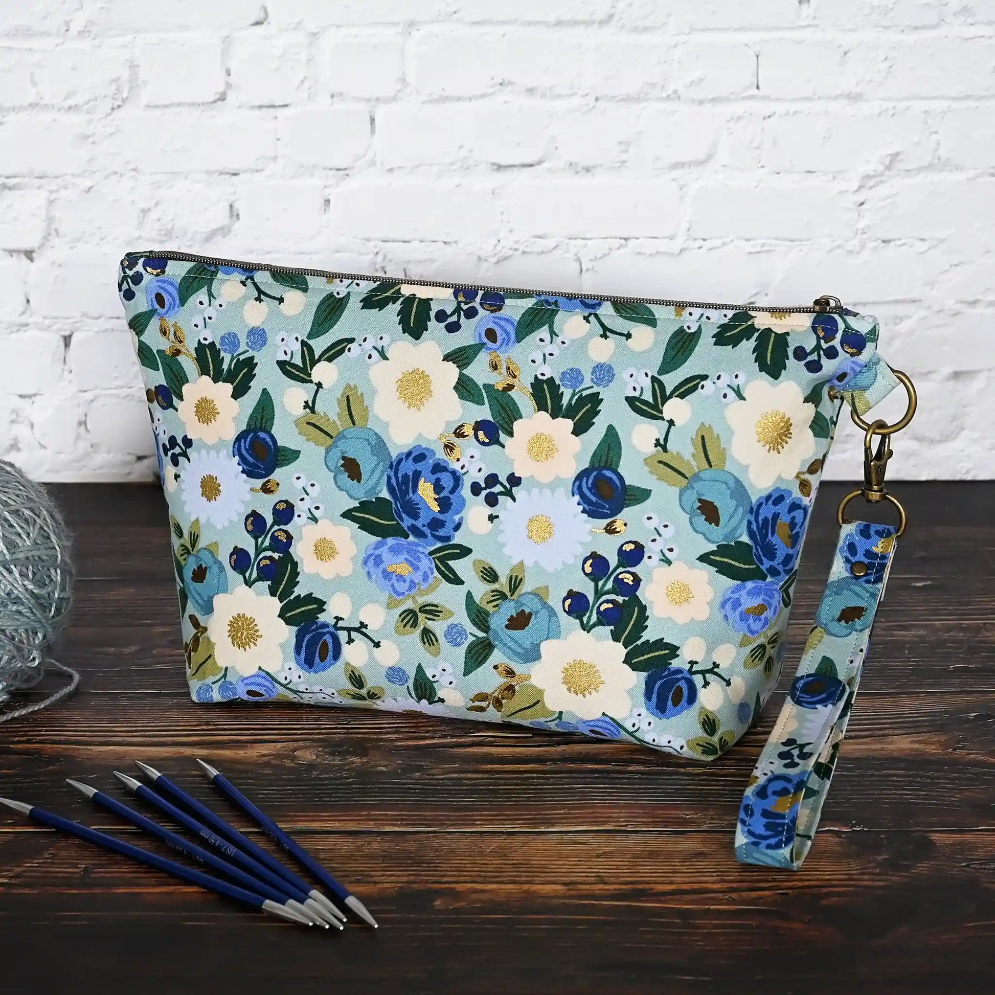 Beautiful pouch in an aqua floral fabric with gold detailing by Rifle Paper Co.  Handmade in Nova Scotia, Canada by Yellow Petal Handmade.