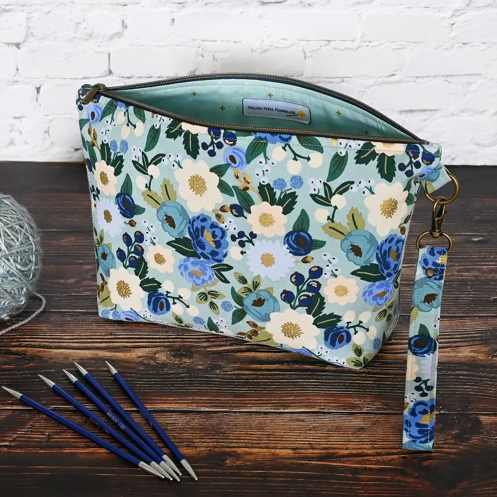 Beautiful pouch in an aqua floral fabric with gold detailing by Rifle Paper Co.  Handmade in Nova Scotia, Canada by Yellow Petal Handmade.