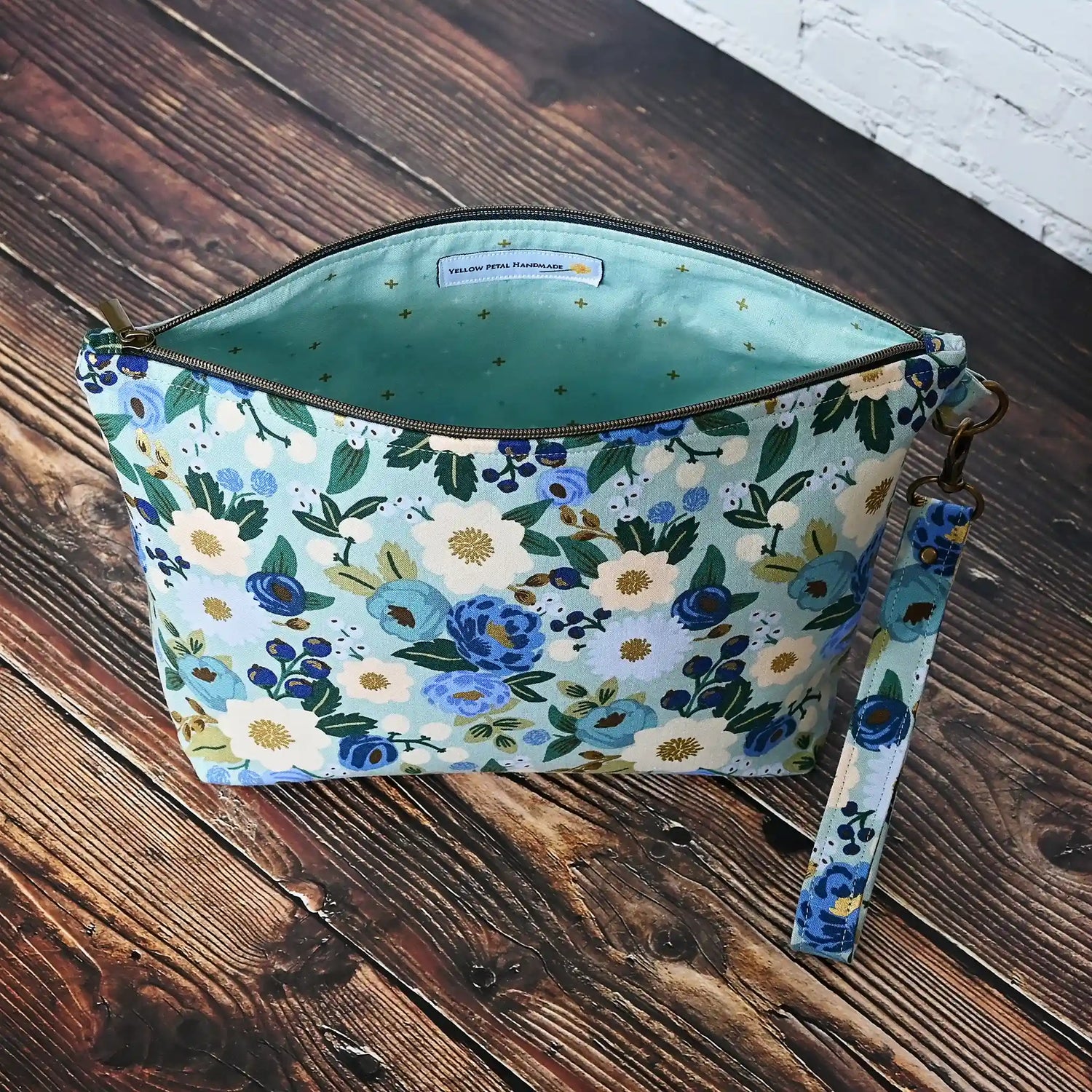Beautiful pouch in an aqua floral fabric with gold detailing by Rifle Paper Co.  Handmade in Nova Scotia, Canada by Yellow Petal Handmade.