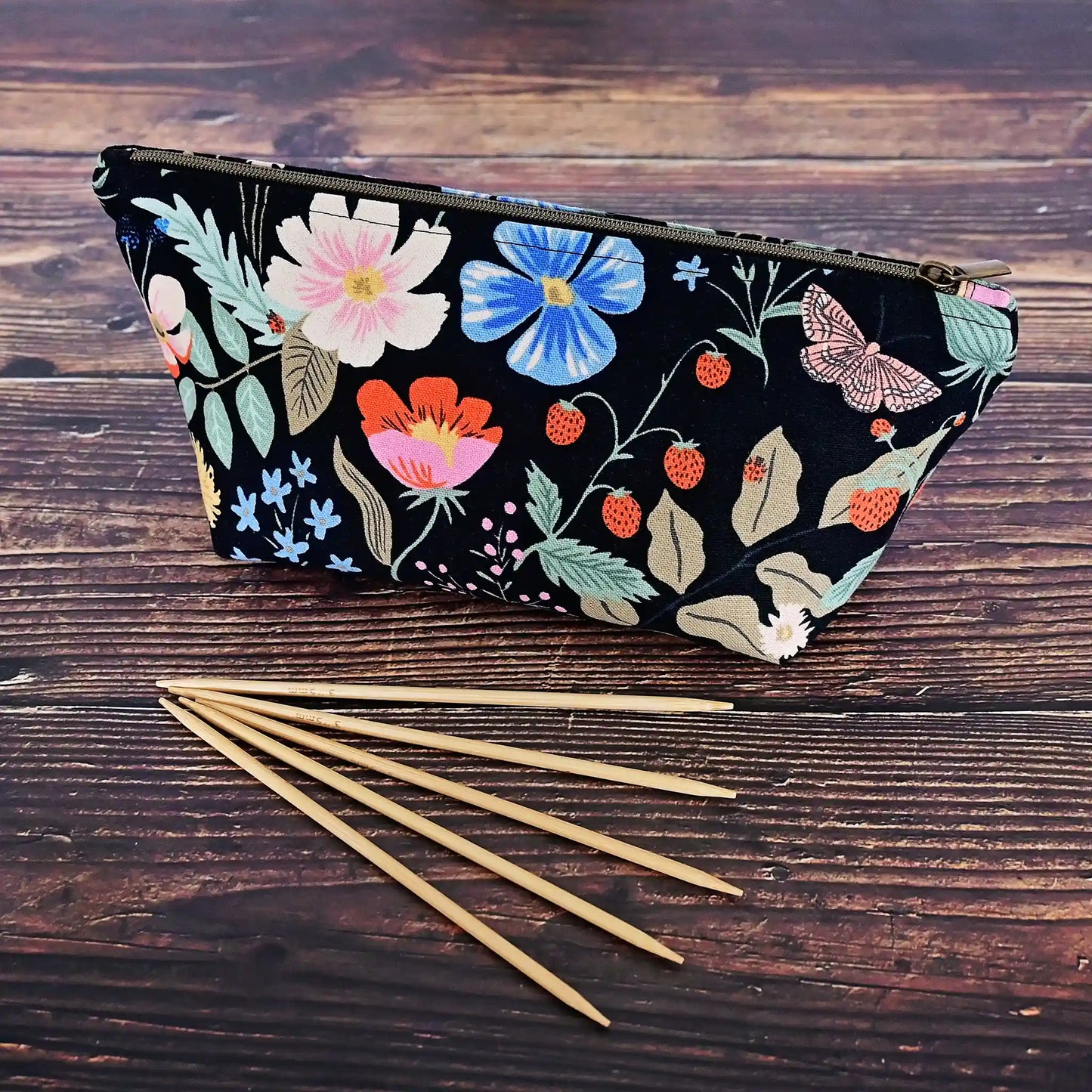 Cute black floral canvas accessory pouch in Rifle Paper Co's Strawberry Fields collection.  Shown with 6" dpns.  Made in Canada by Yellow Petal Handmade.