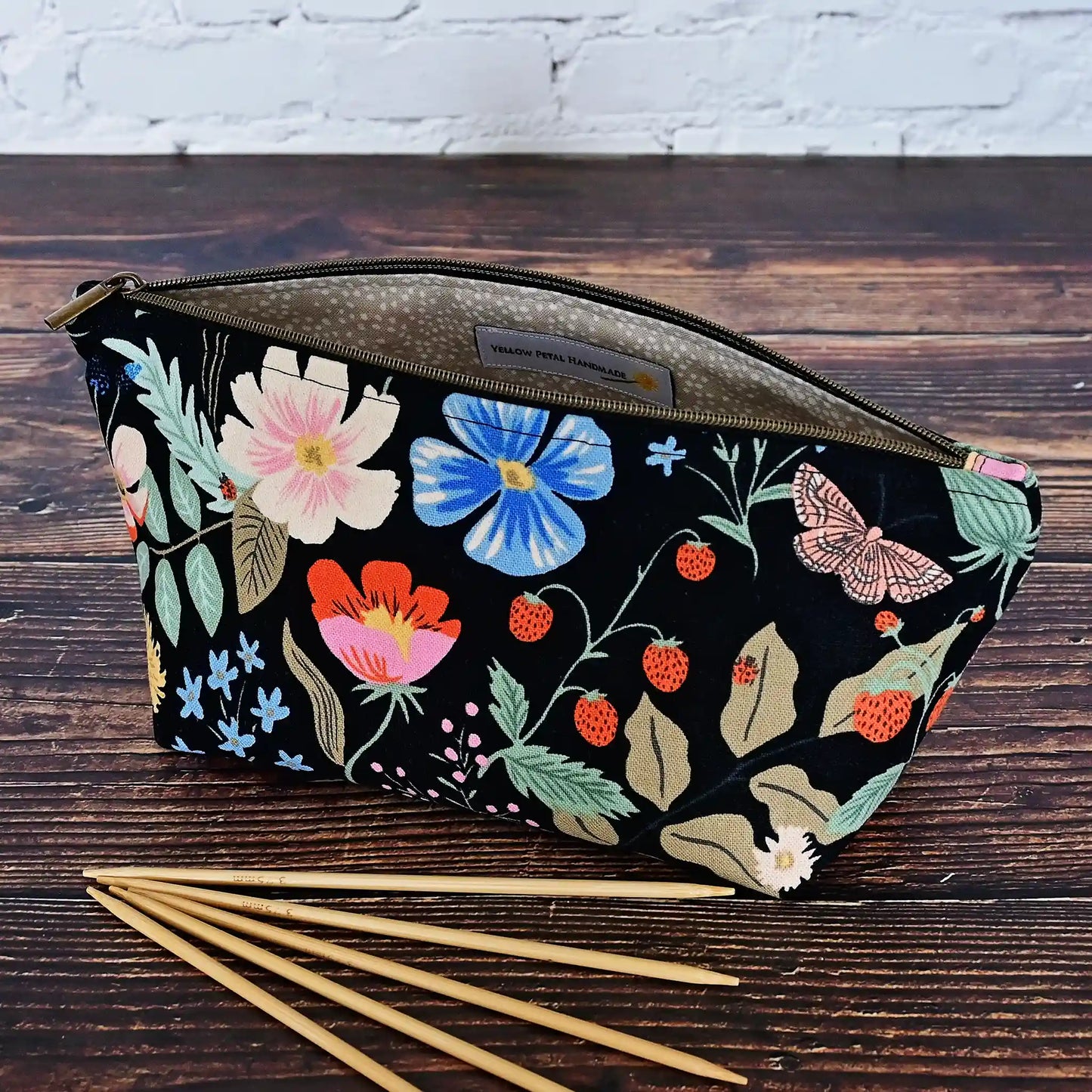 Cute black floral canvas accessory pouch in Rifle Paper Co's Strawberry Fields collection.  Shown with 6" dpns.  Made in Canada by Yellow Petal Handmade.