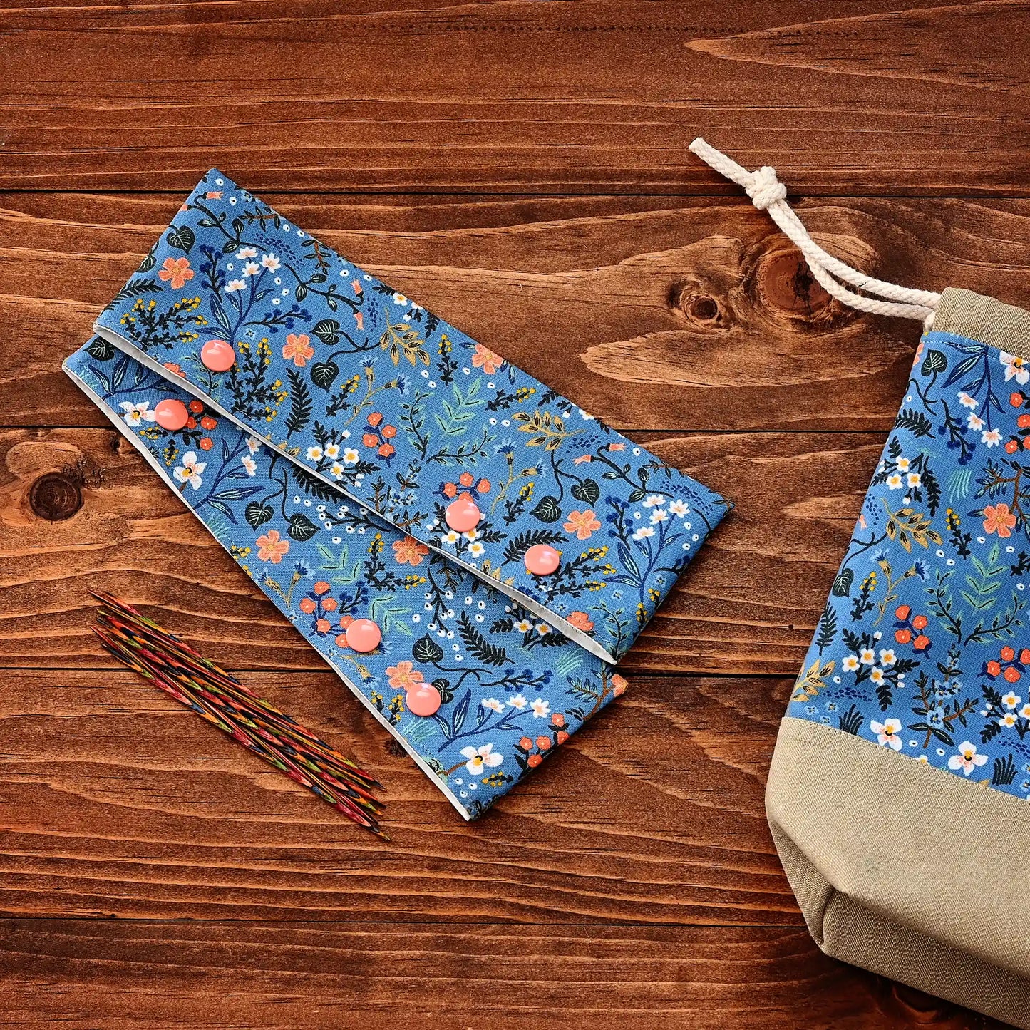 Pretty blue floral DPN cozies, meant to keep your knitting securely on the needles when you aren't working on it.  These are made from a blue floral on the outside and a delicate white floral inside.  They close with your choice of blue or peach snaps.  Made in Nova Scotia, Canada by Yellow Petal Handmade.