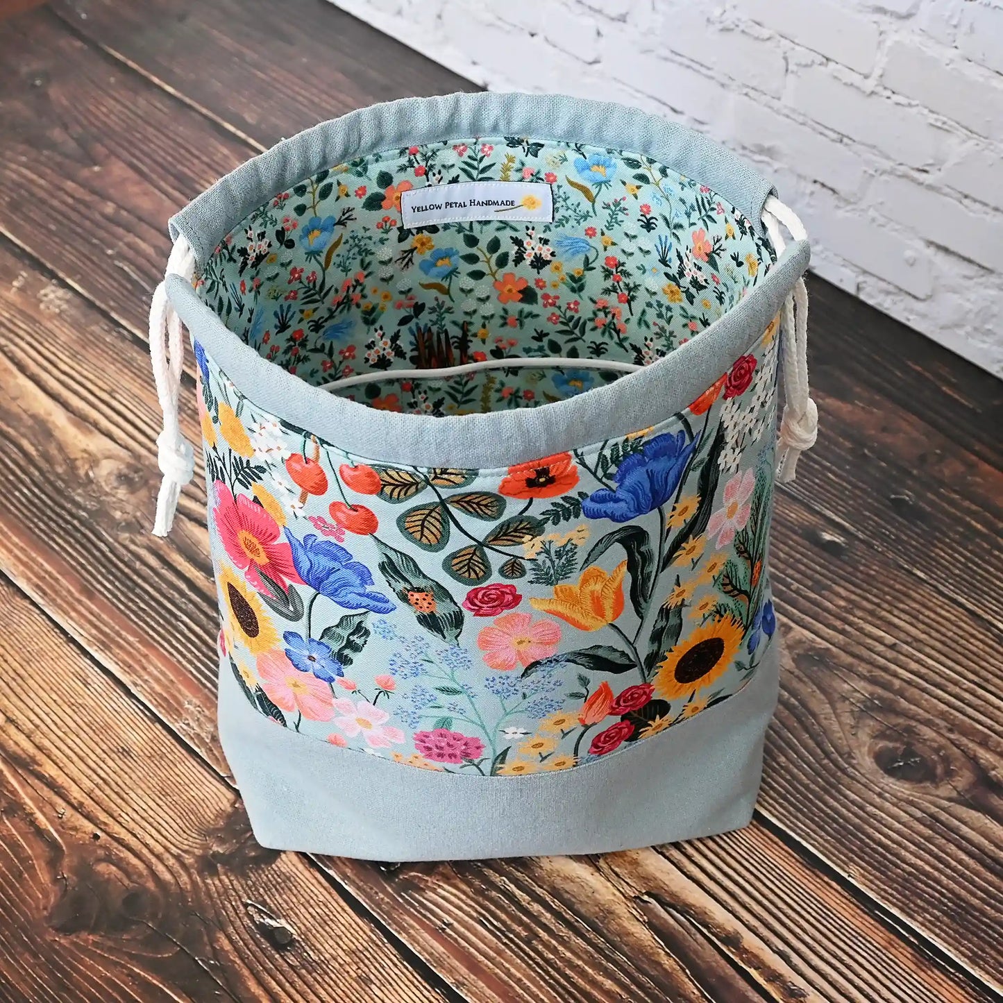Pretty muted blue grey floral project bag with pockets and a drawstring closure.  This bag is made with Rifle Paper Co's Curio collection, inside and out.  Made in Canada by Yellow Petal Handmade.