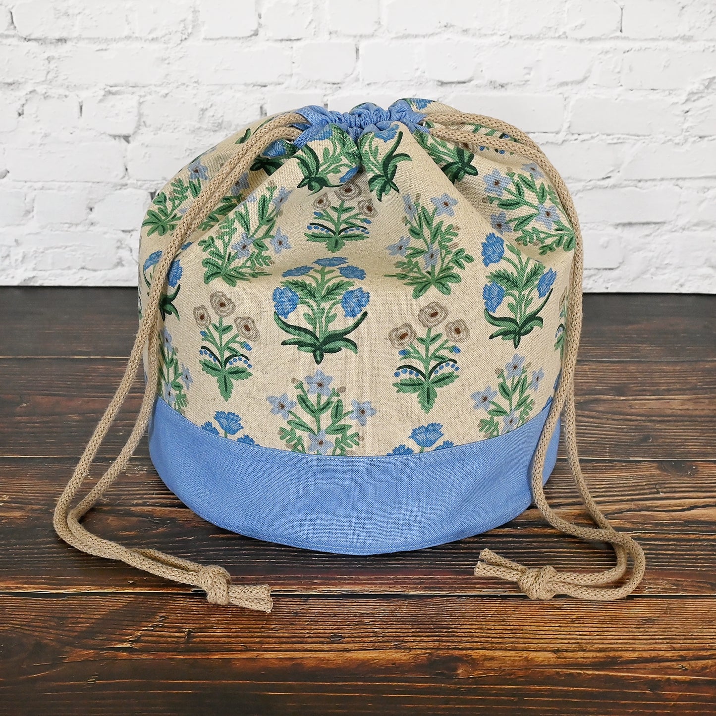 Canvas bucket bag in a pretty floral and periwinkle canvas/linen combinations.  Made with plenty of interior pockets and a quilted bottom for stability and design.  Made in Canada by Yellow Petal Handmade.