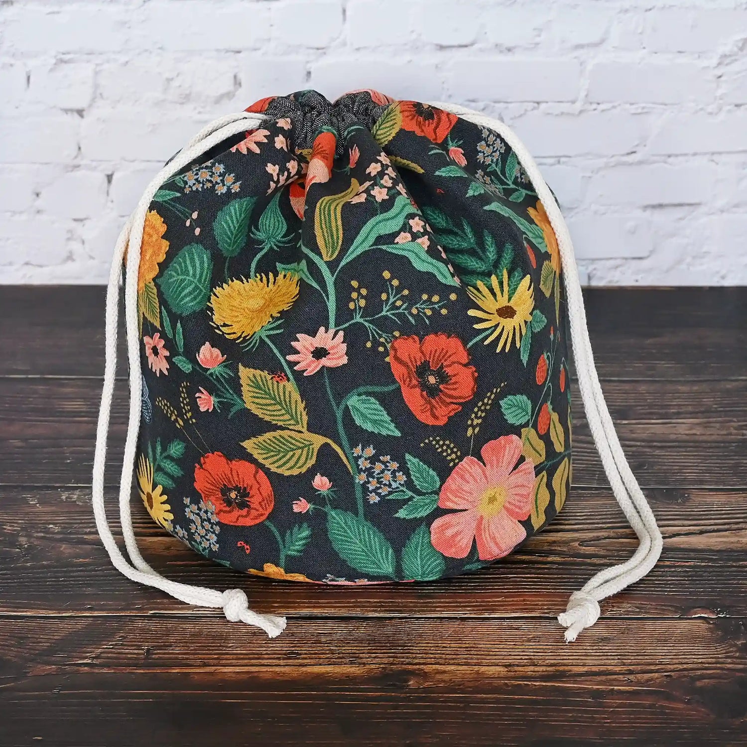 Black floral canvas bucket style project bag with pretty gold cotton interior.  Made from the Camont collection by Rifle Paper Co.  Made in Canada by Yellow Petal Handmade.