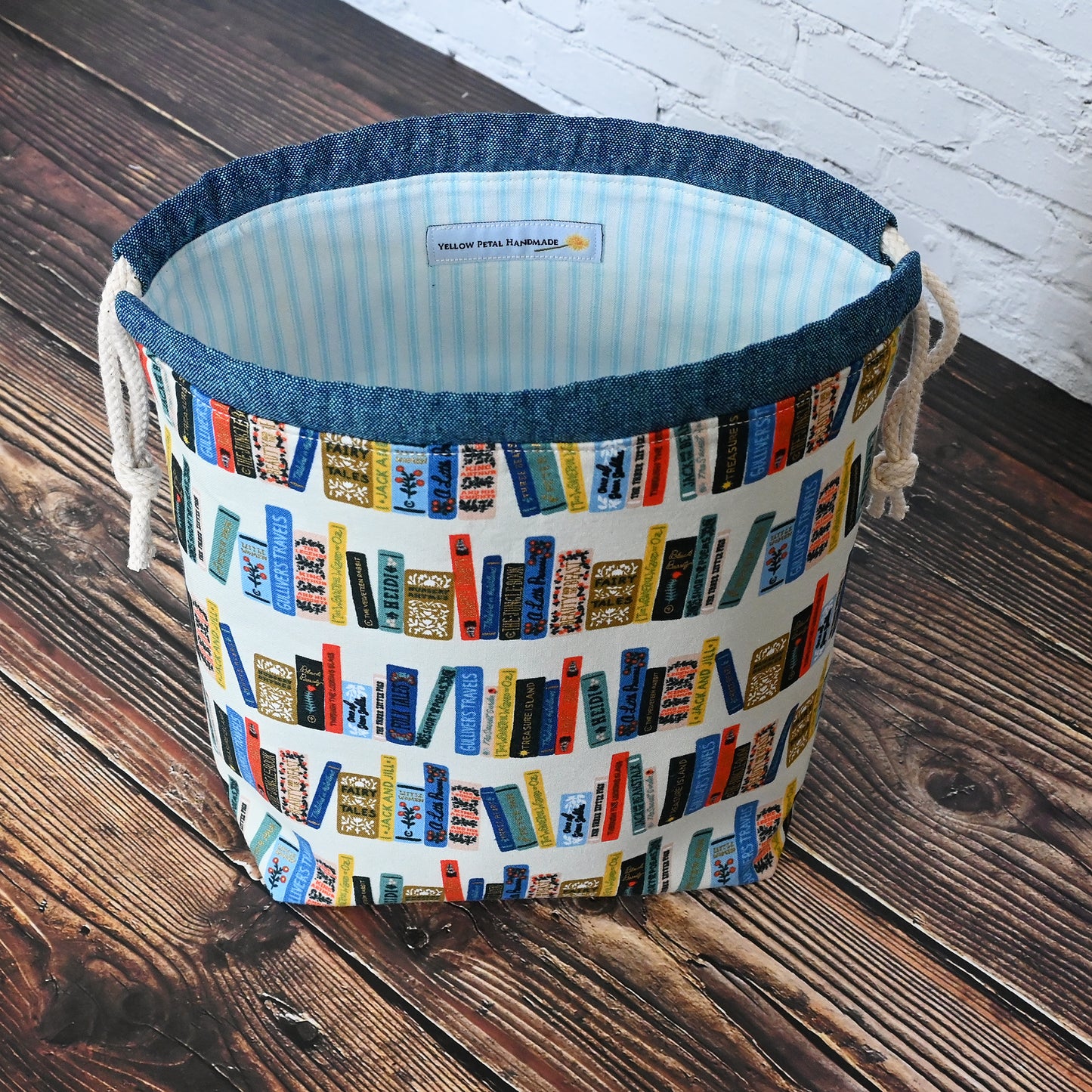 Book Club drawstring project bag from Rifle Paper's Curio collection.  Lined in a pretty blue and white striped cotton.  Made in Canada by Yellow Petal Handmade.