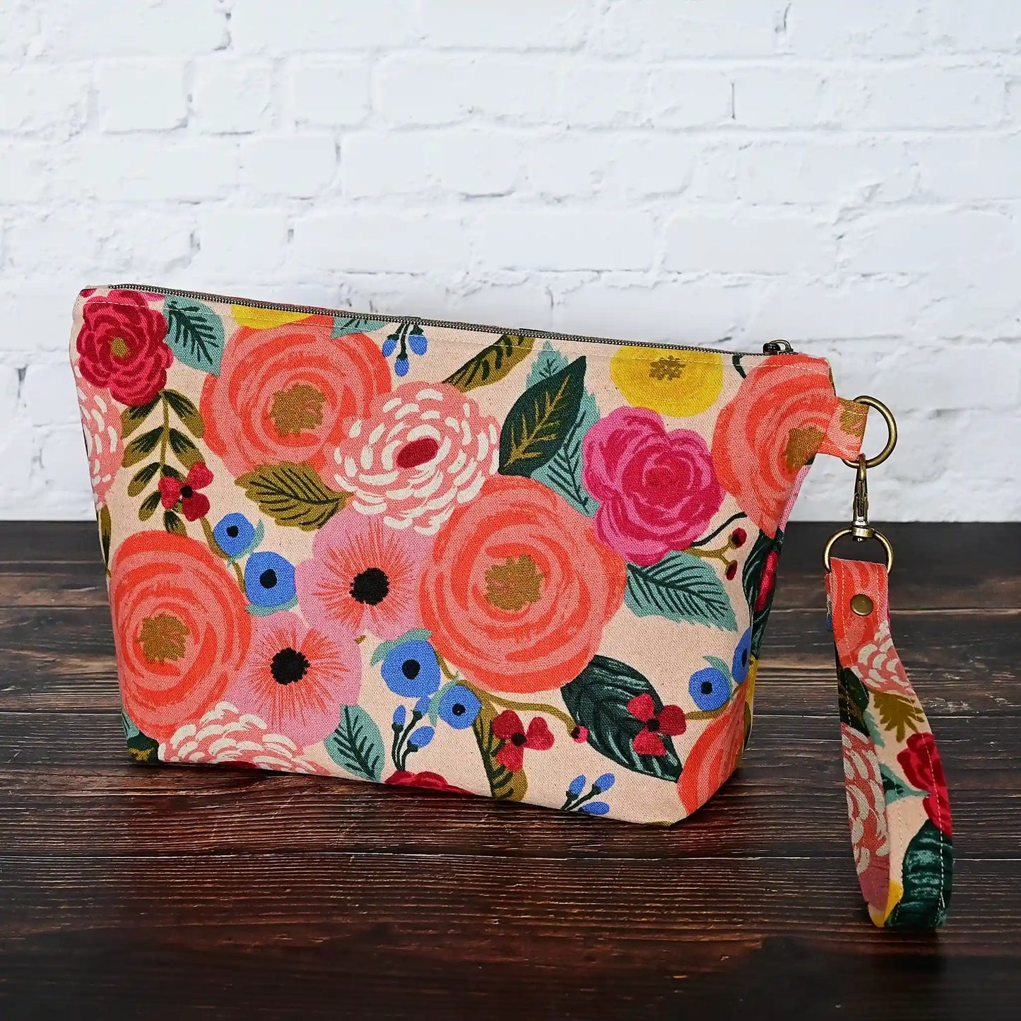 Pretty peach floral canvas pouch with removable wrist strap.  Lined in peach cotton with Gold Stars.  All fabrics from Rifle Paper Co.  Made in Nova Scotia, Canada by Yellow Petal Handmade.